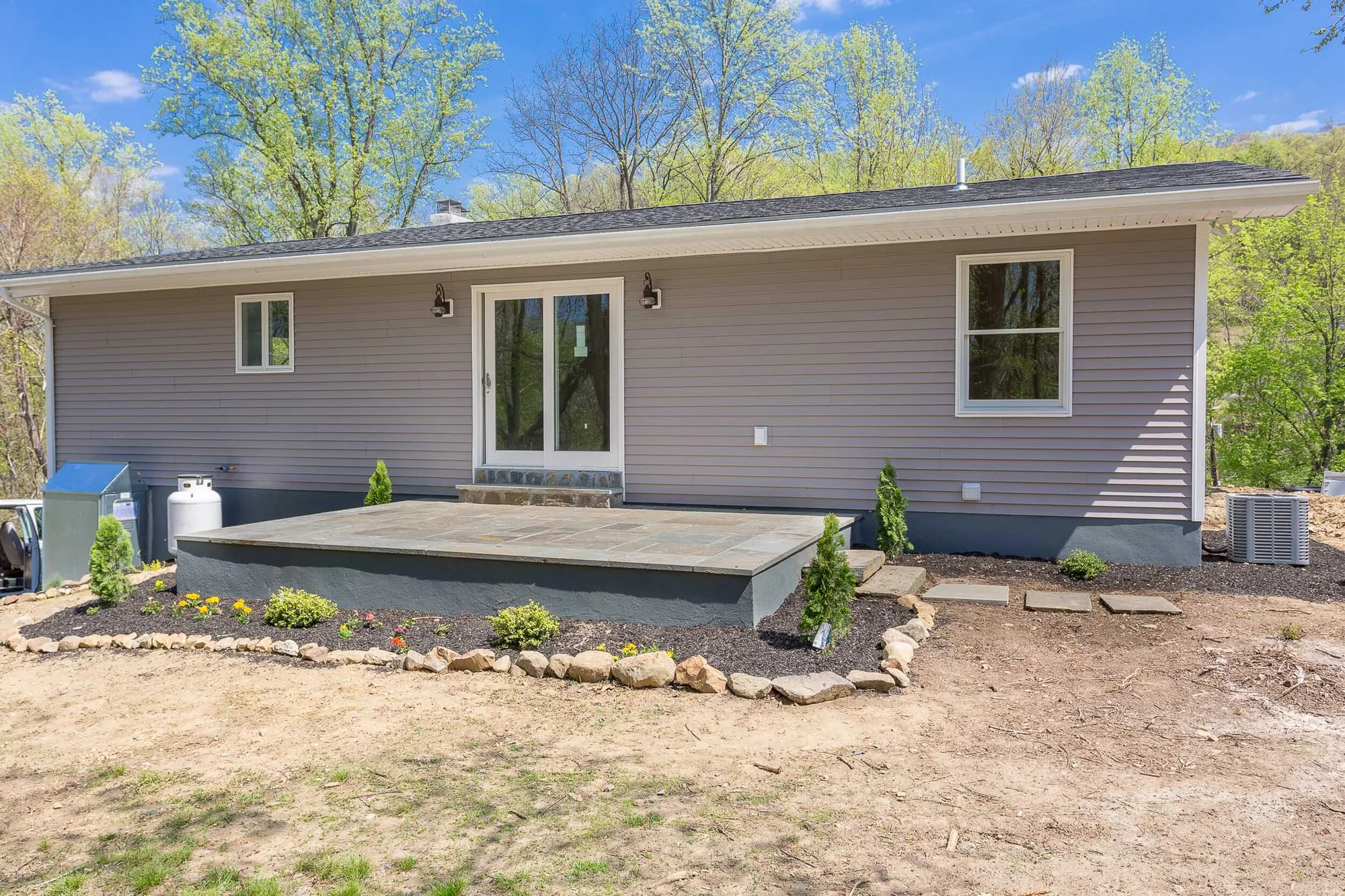 Rear exterior with slate patio and landscaping
