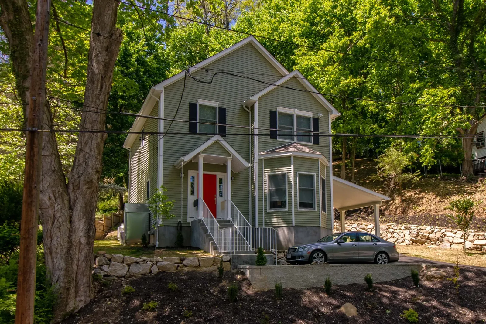 Front entry with a red craftsman door and gray siding