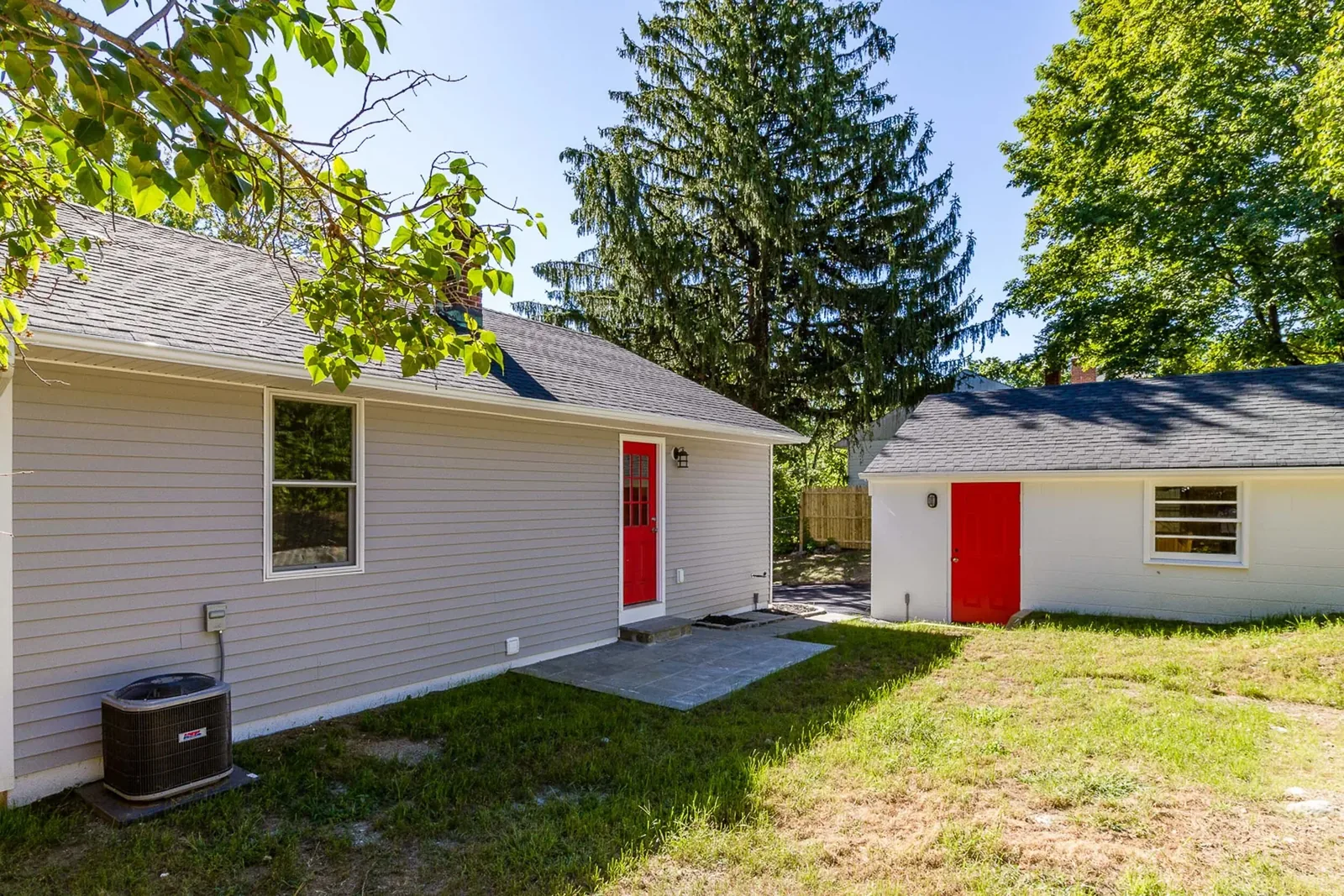 Rear exterior with red door and bluestone patio