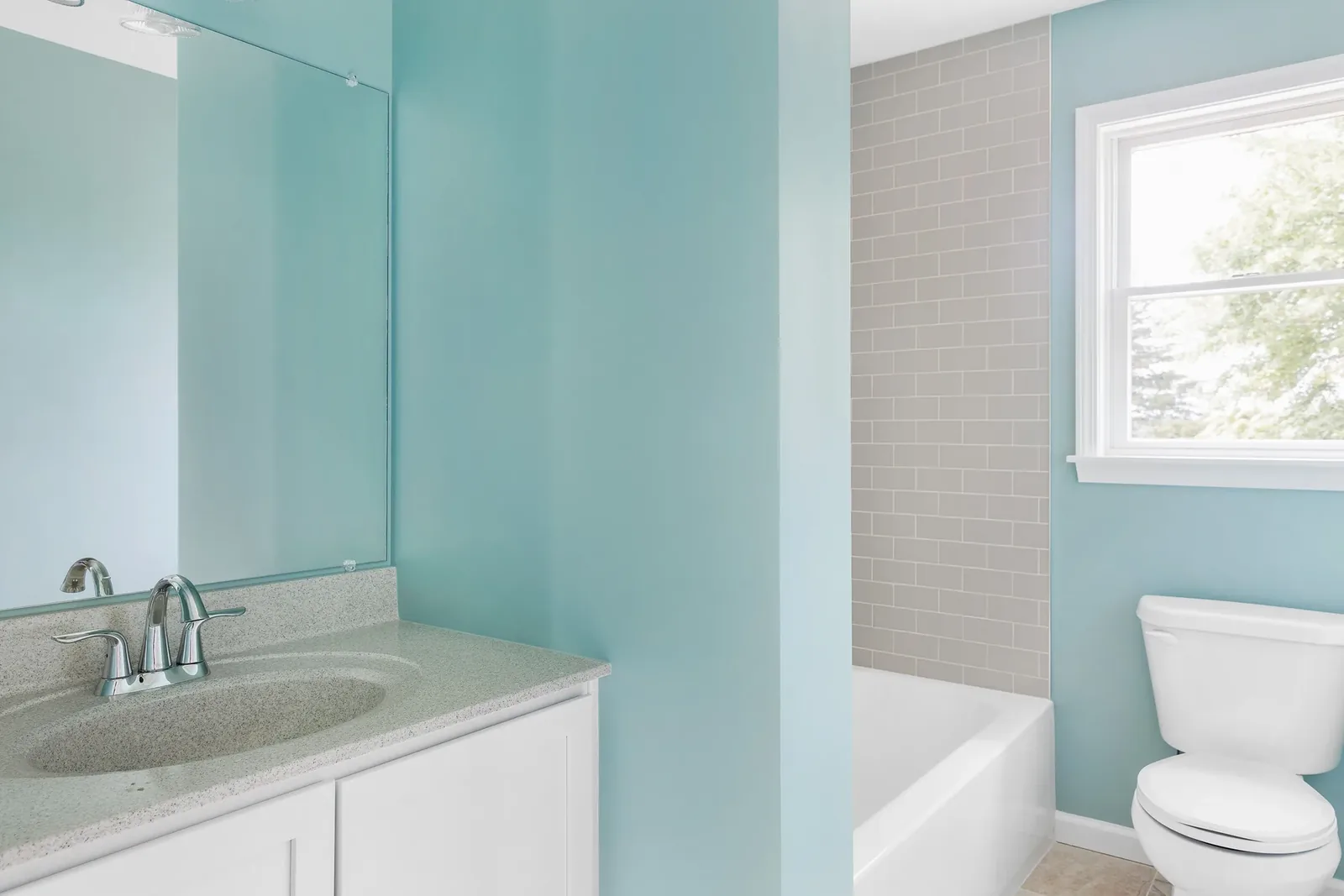 Bathroom with tub and subway-tile surround