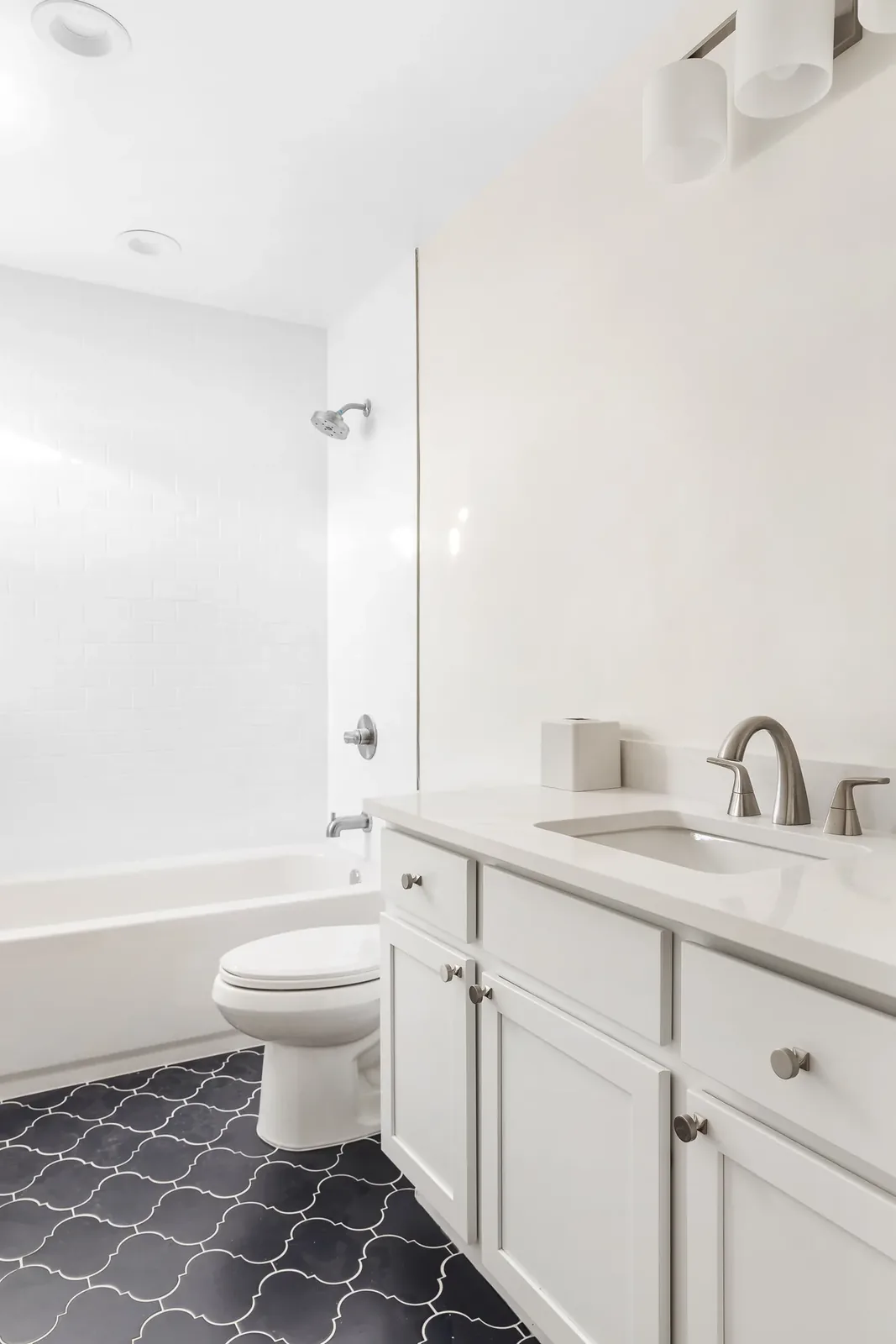 Bathroom with tub, toilet, and vanity
