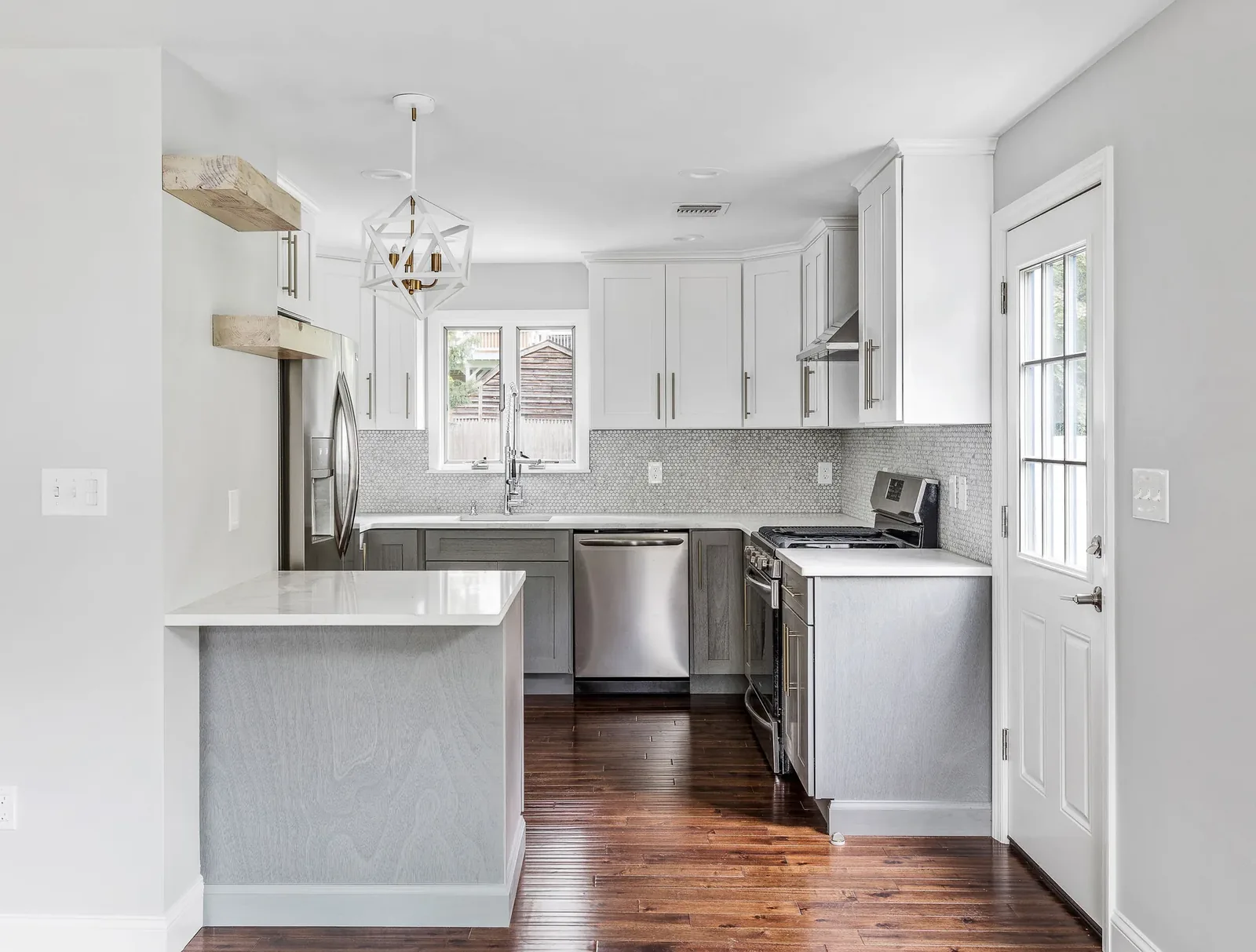 White and gray kitchen with penny-round tile and wood shelves