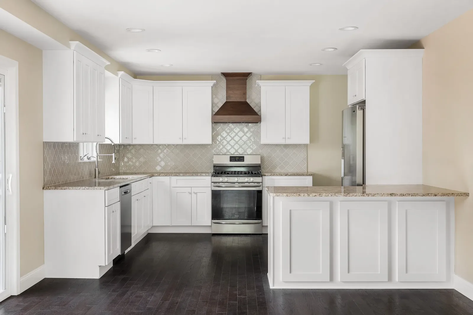 Gray kitchen with white uppers and marble-look island
