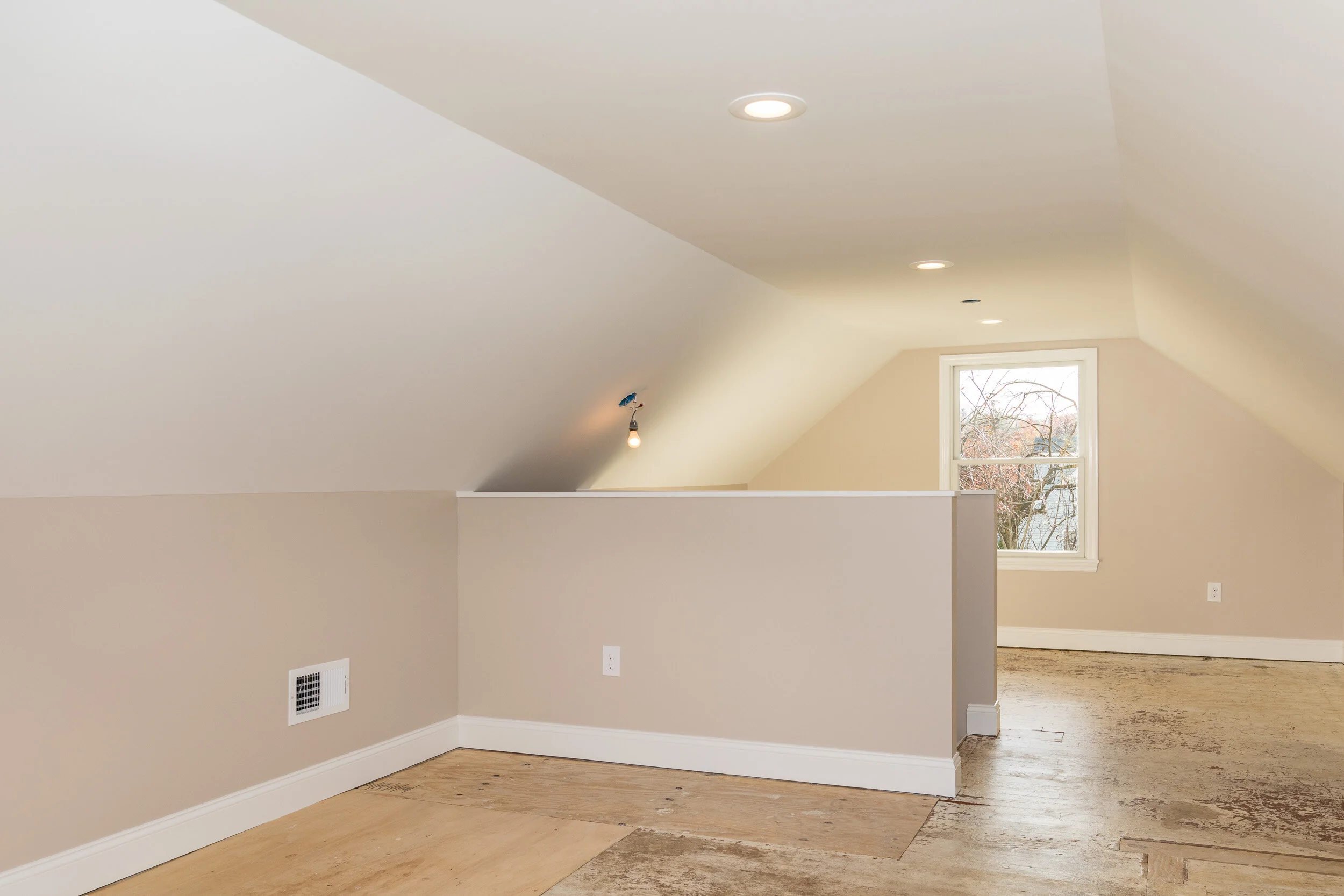 Finished bonus room under the eaves with a sloped ceiling
