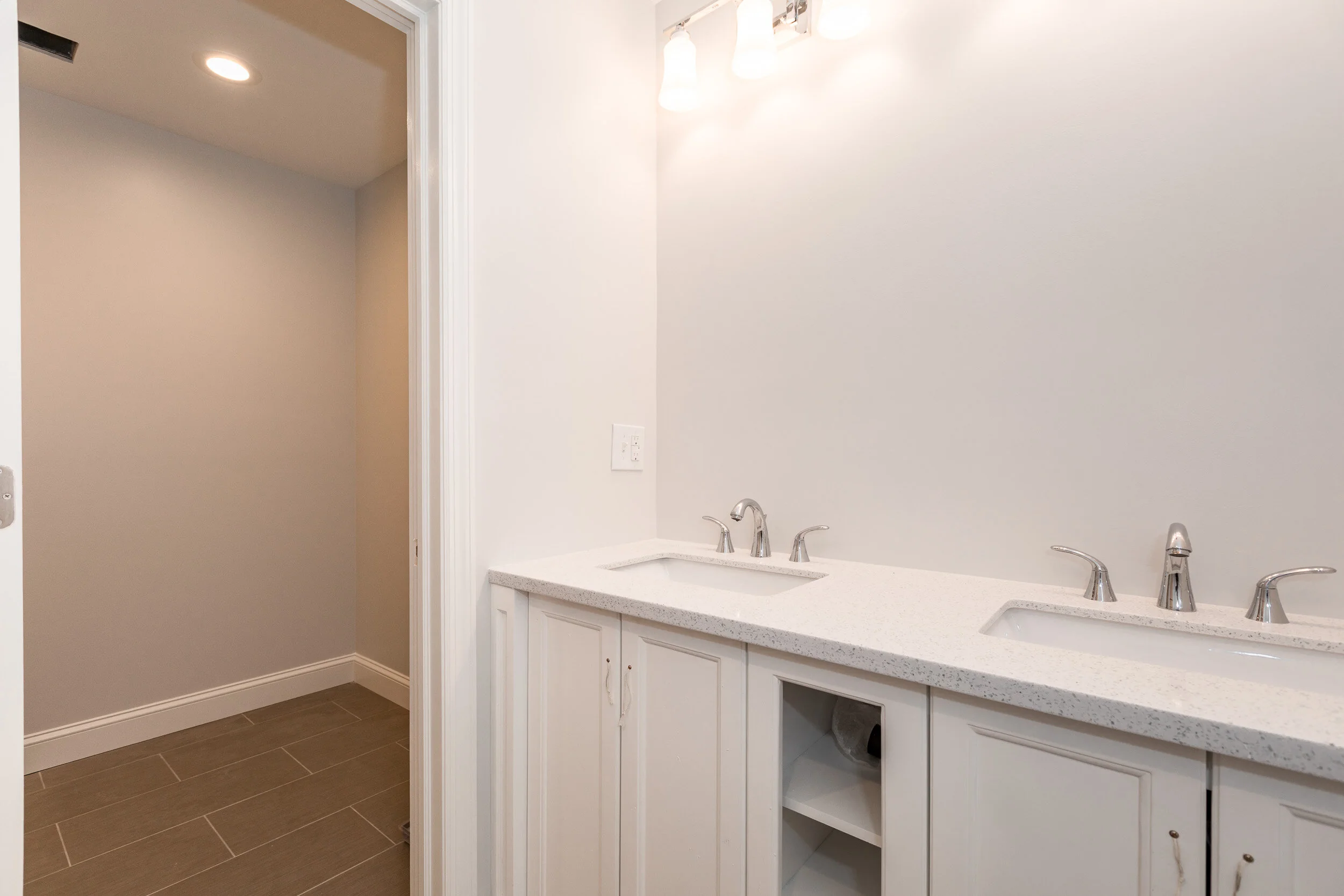 Remodeled bathroom with a double vanity and quartz counters