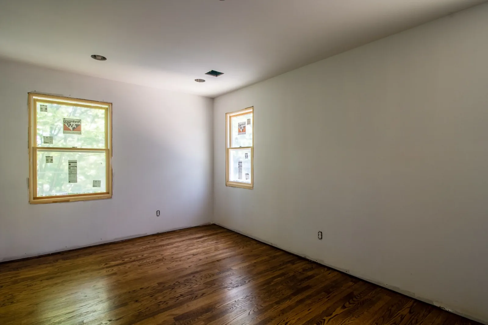 Bedroom with soft sage-gray walls and hardwood floors