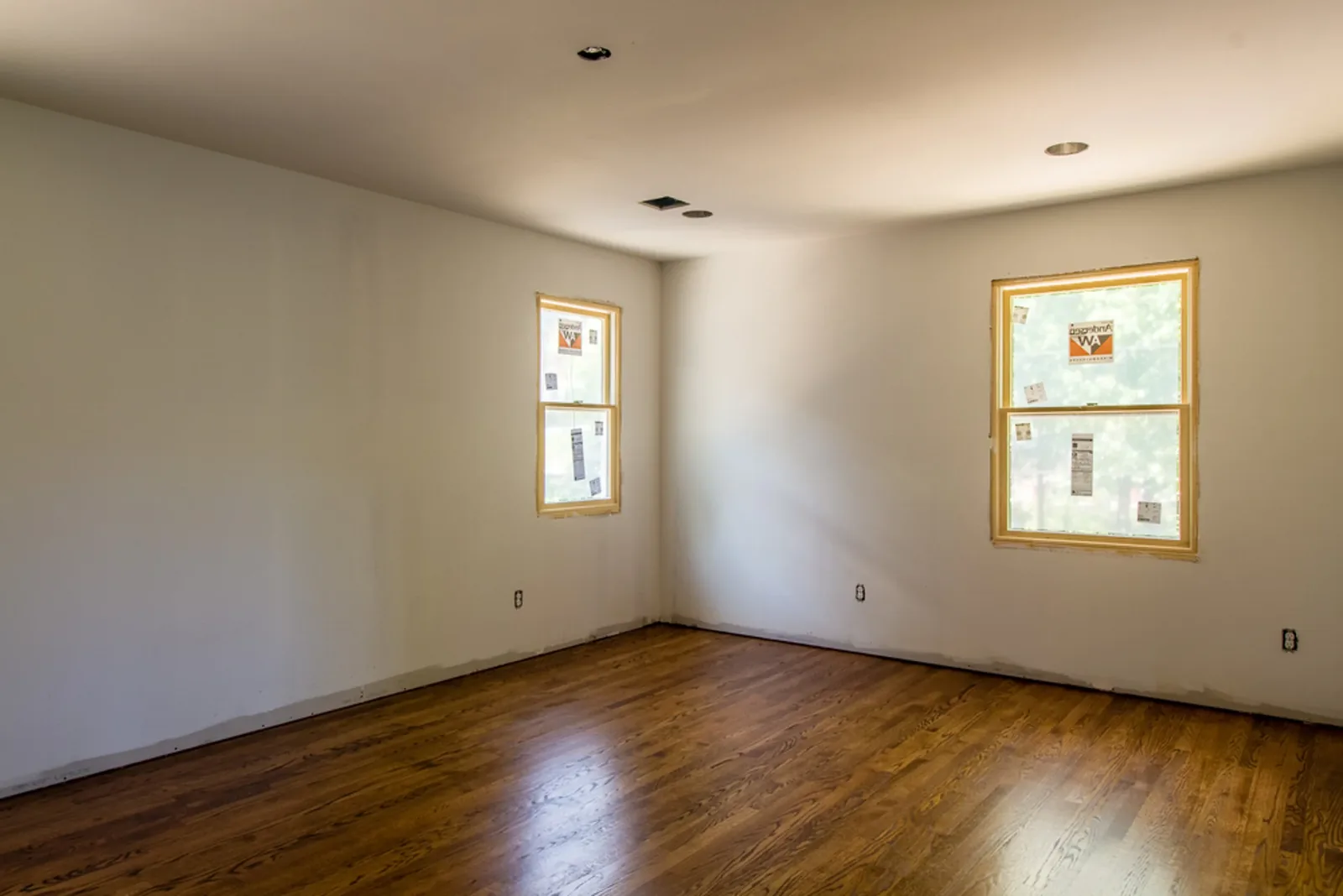 Corner room with soft gray walls and two windows