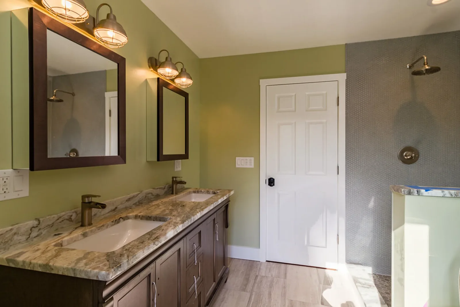 Hall bath with a granite double vanity and framed mirror