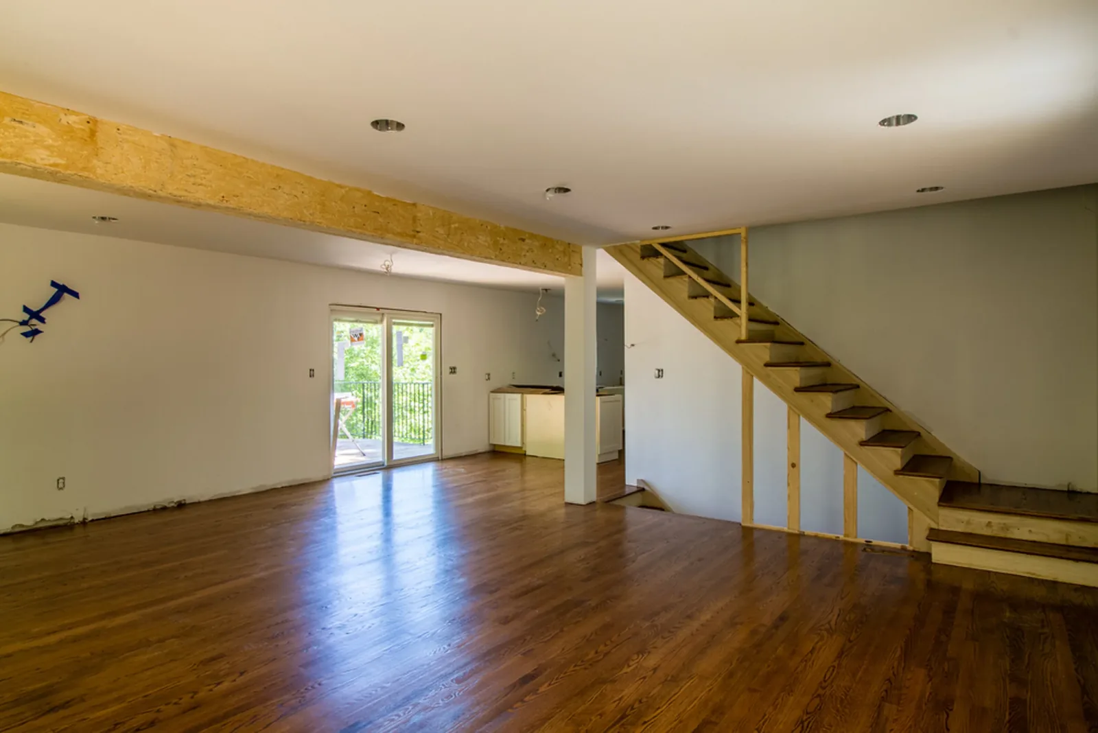 Open floor plan with a staircase and hardwood floors