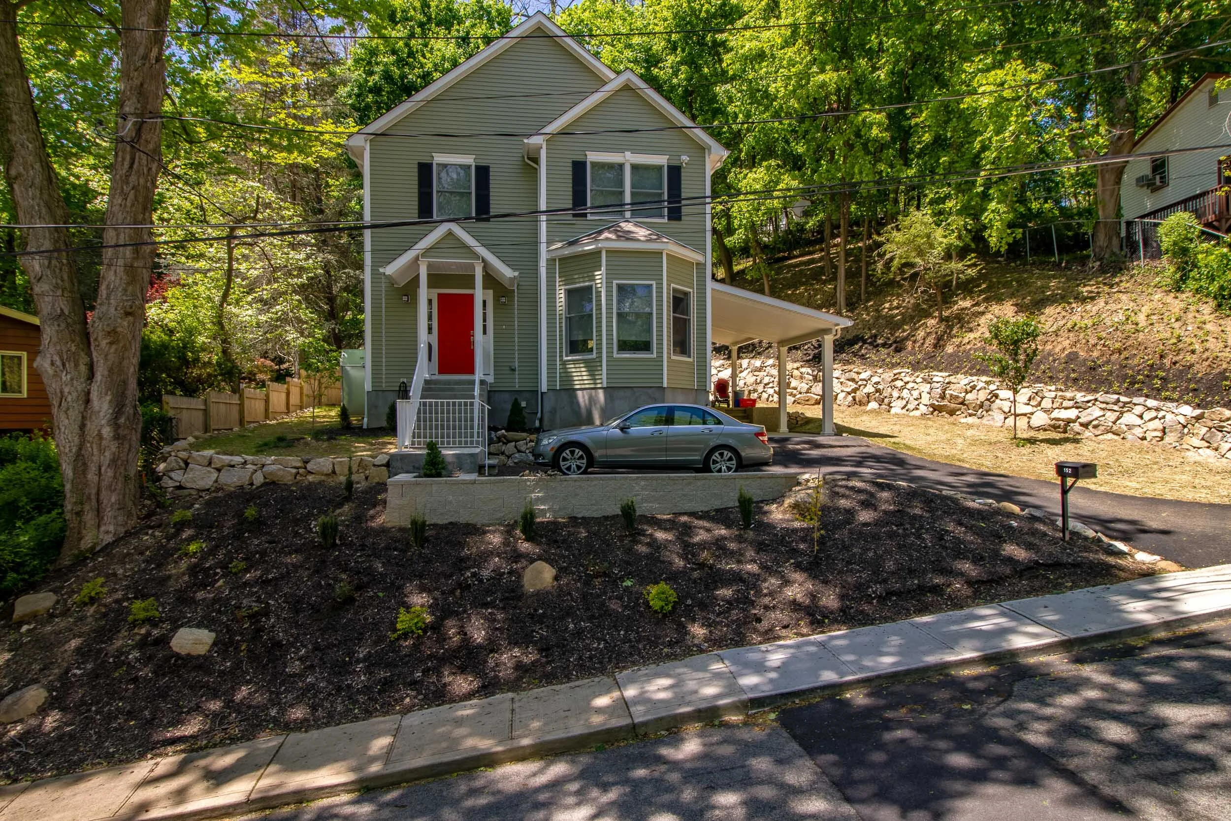 Exterior of the finished modular home with carport