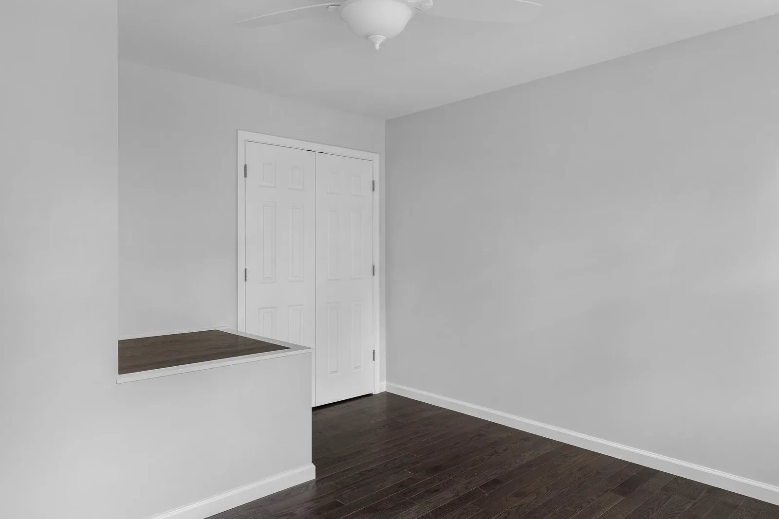 Room with double closet and hardwood floors
