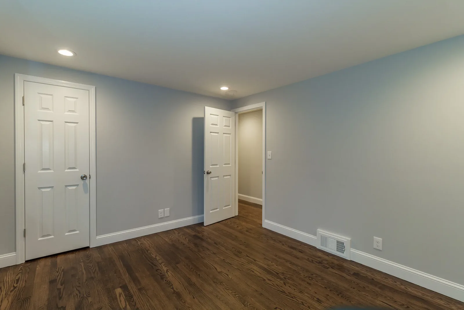 Room with soft blue-gray walls and hardwood floors