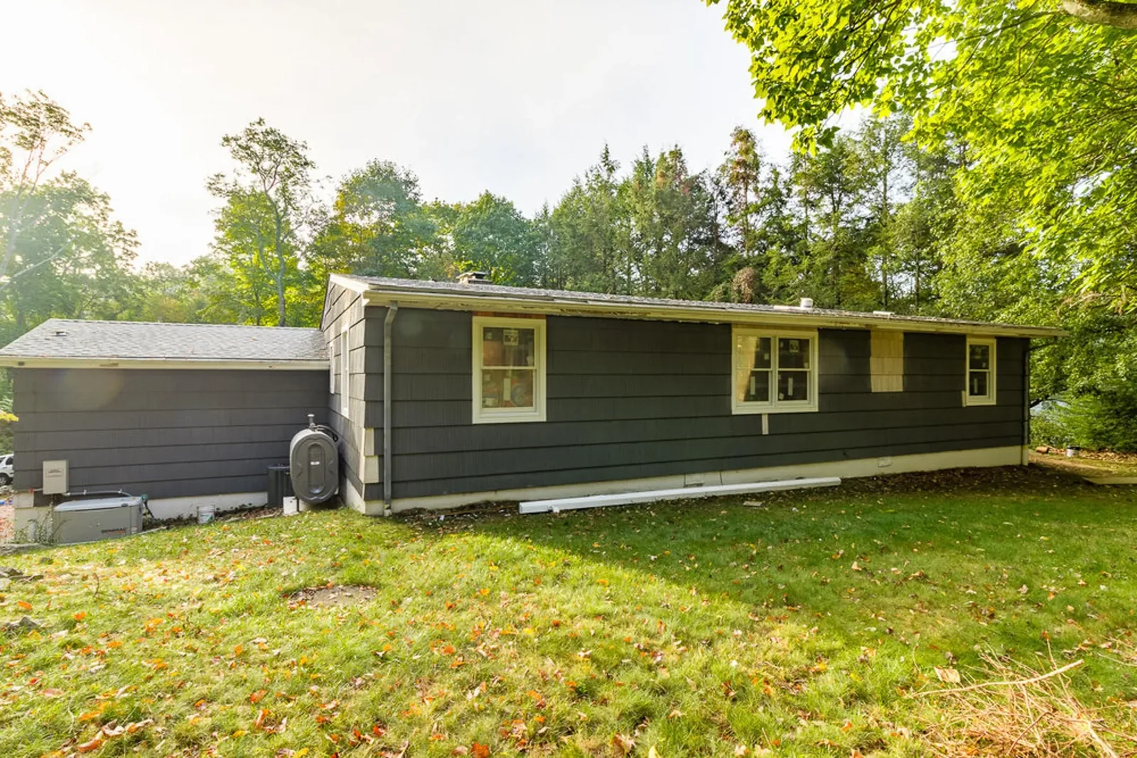 Side exterior of the ranch with dark lap siding