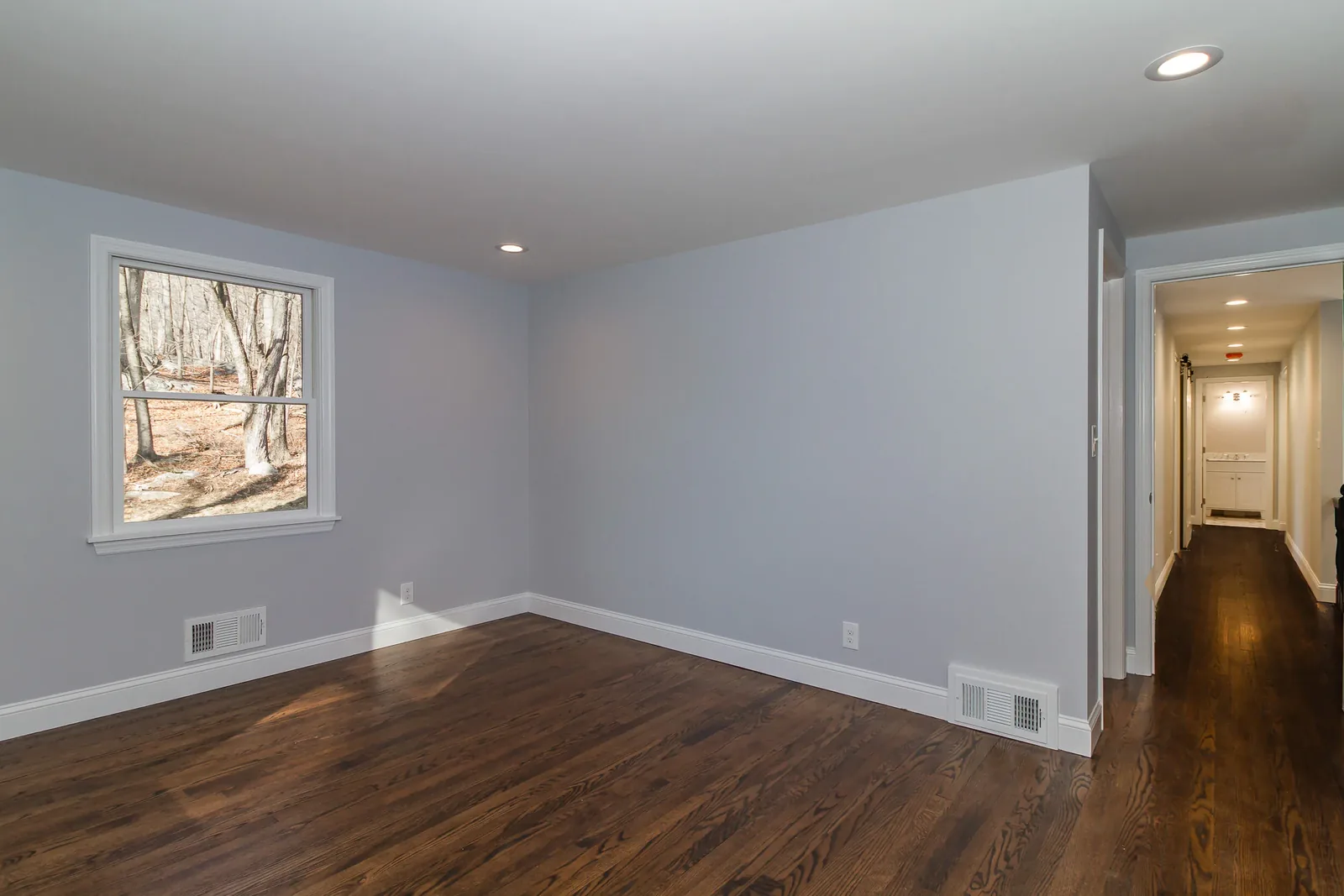 Bright room with hardwood floors and a large window