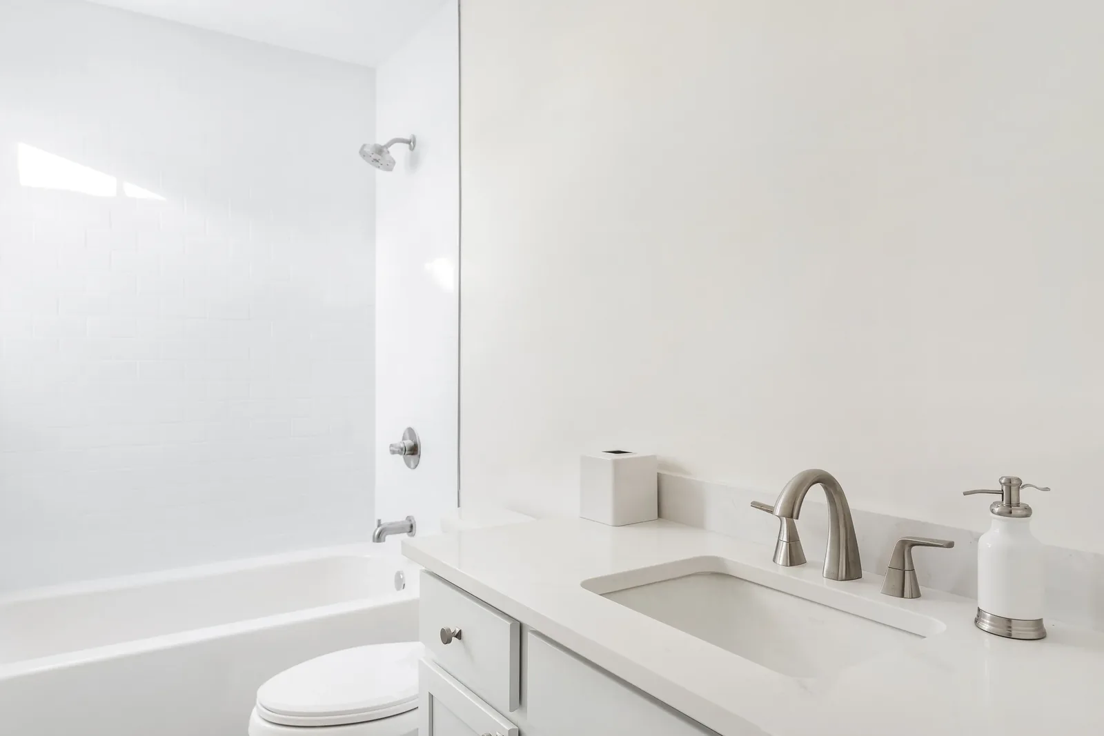 Bath with a white tub surround and a single vanity