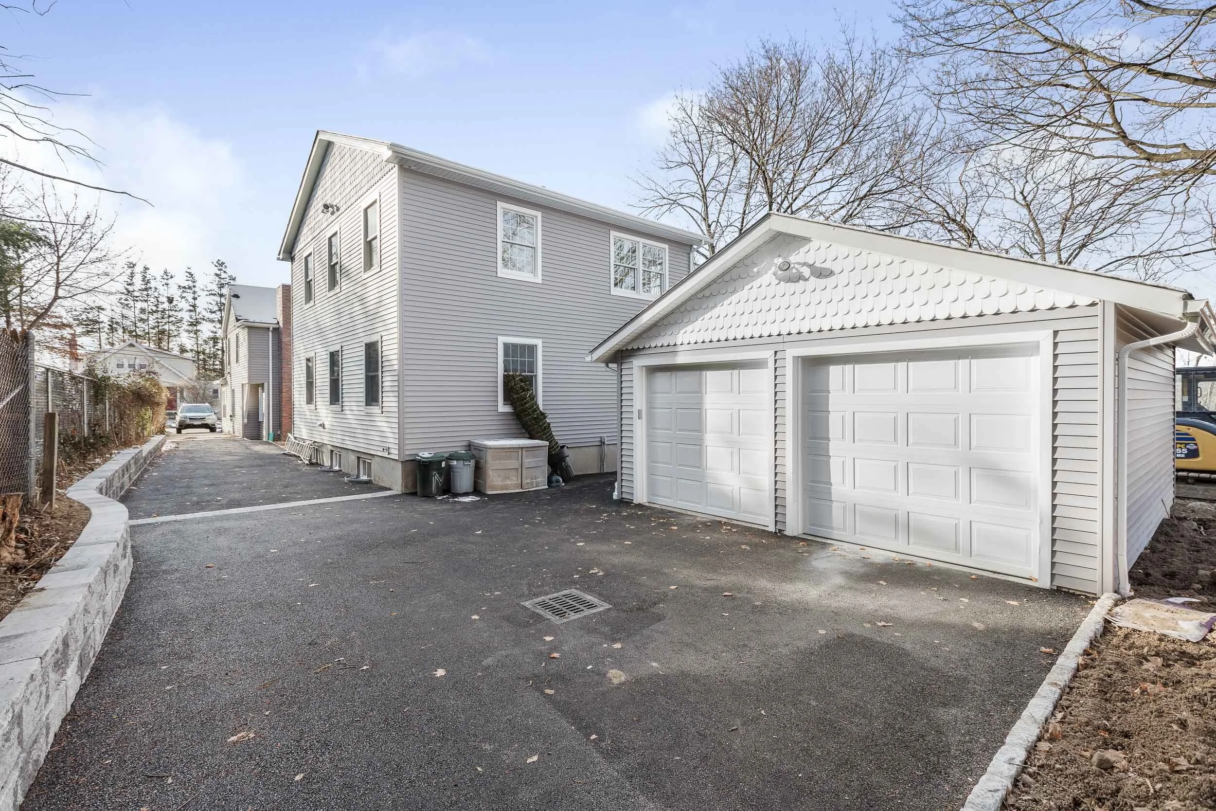 Front exterior of the renovated colonial with a new detached garage at 51 Orchard St