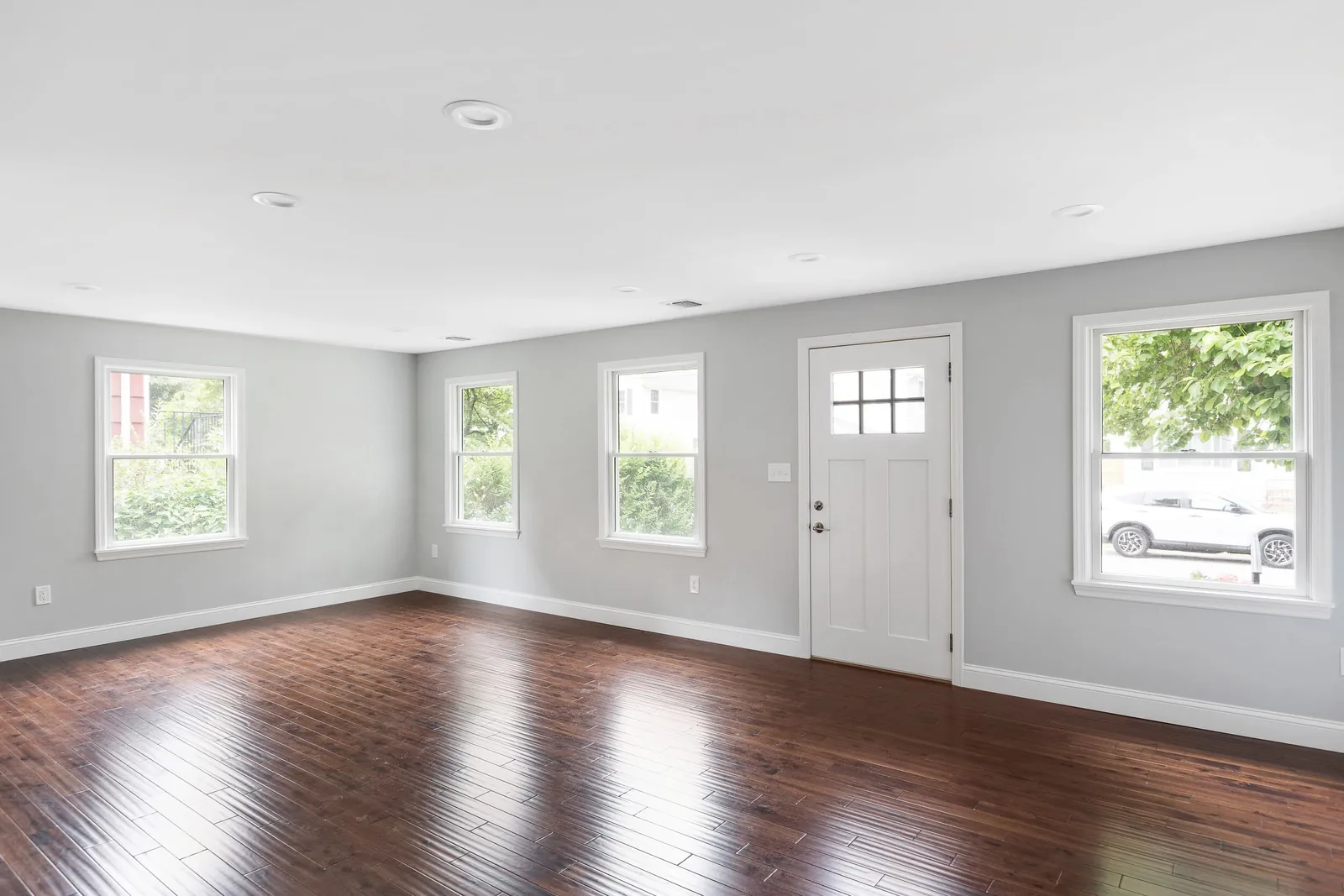 Living room with the front door and street-side windows