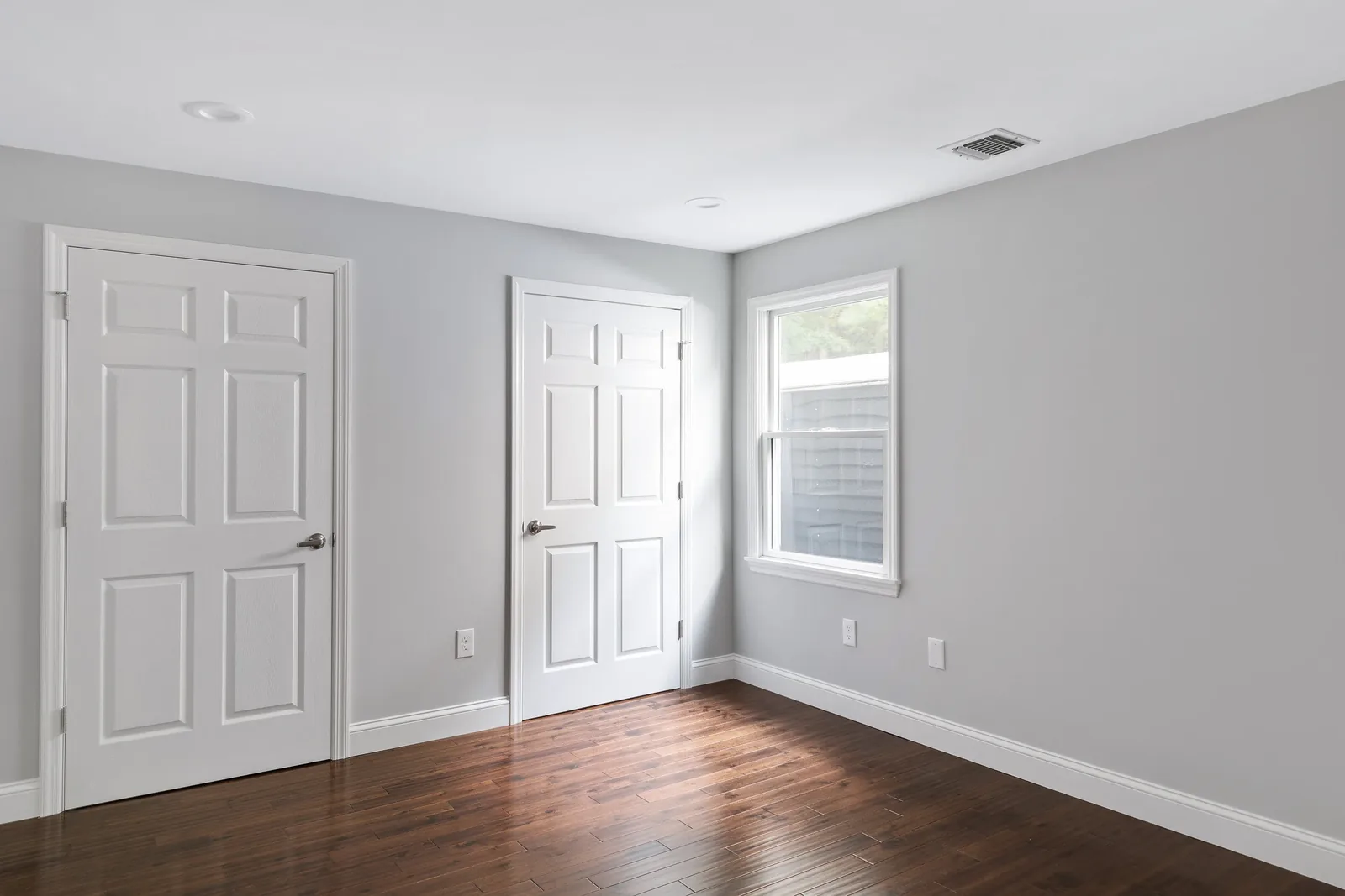 Bedroom with closet and hardwood floors