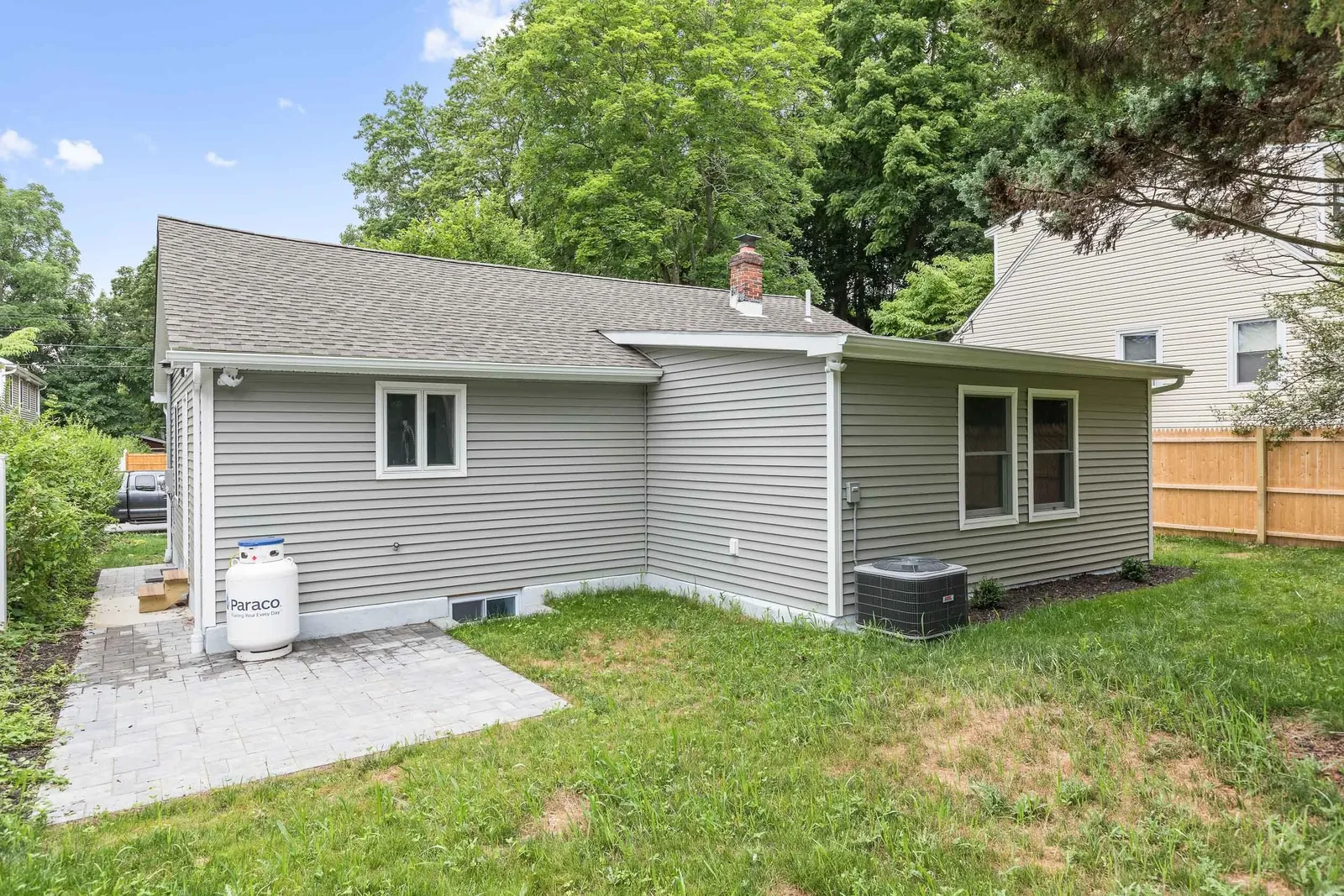 Rear exterior with new siding and paver walkway