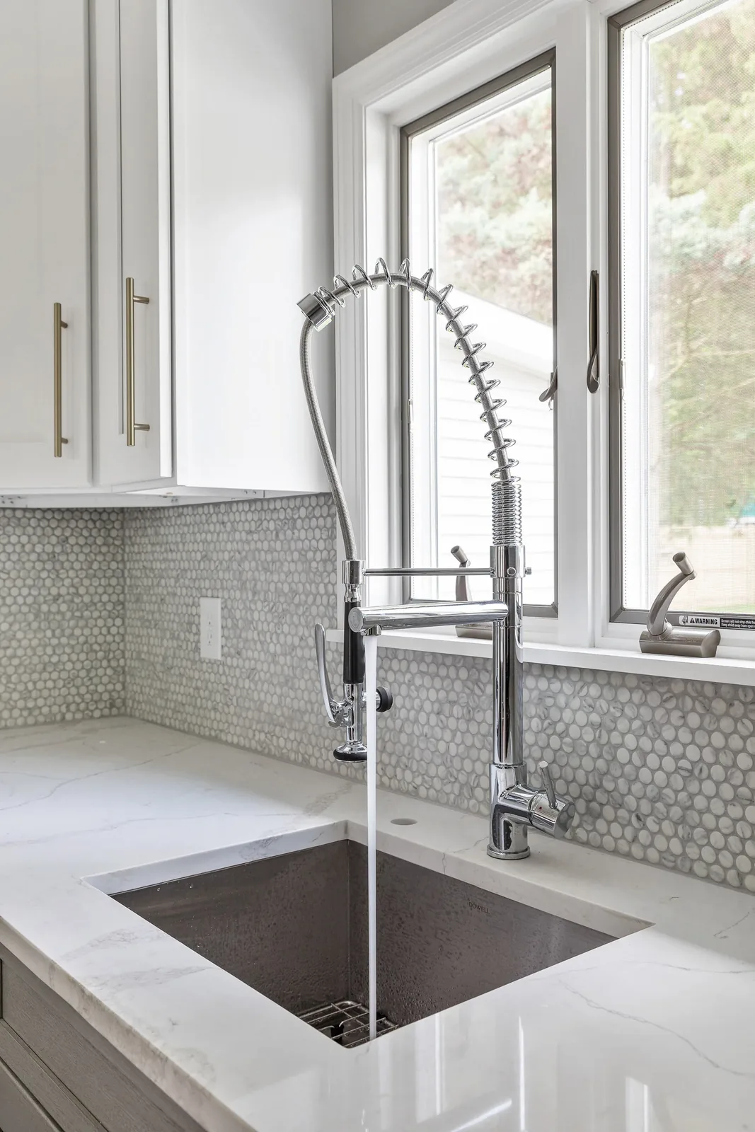 Pull-down faucet over the undermount sink