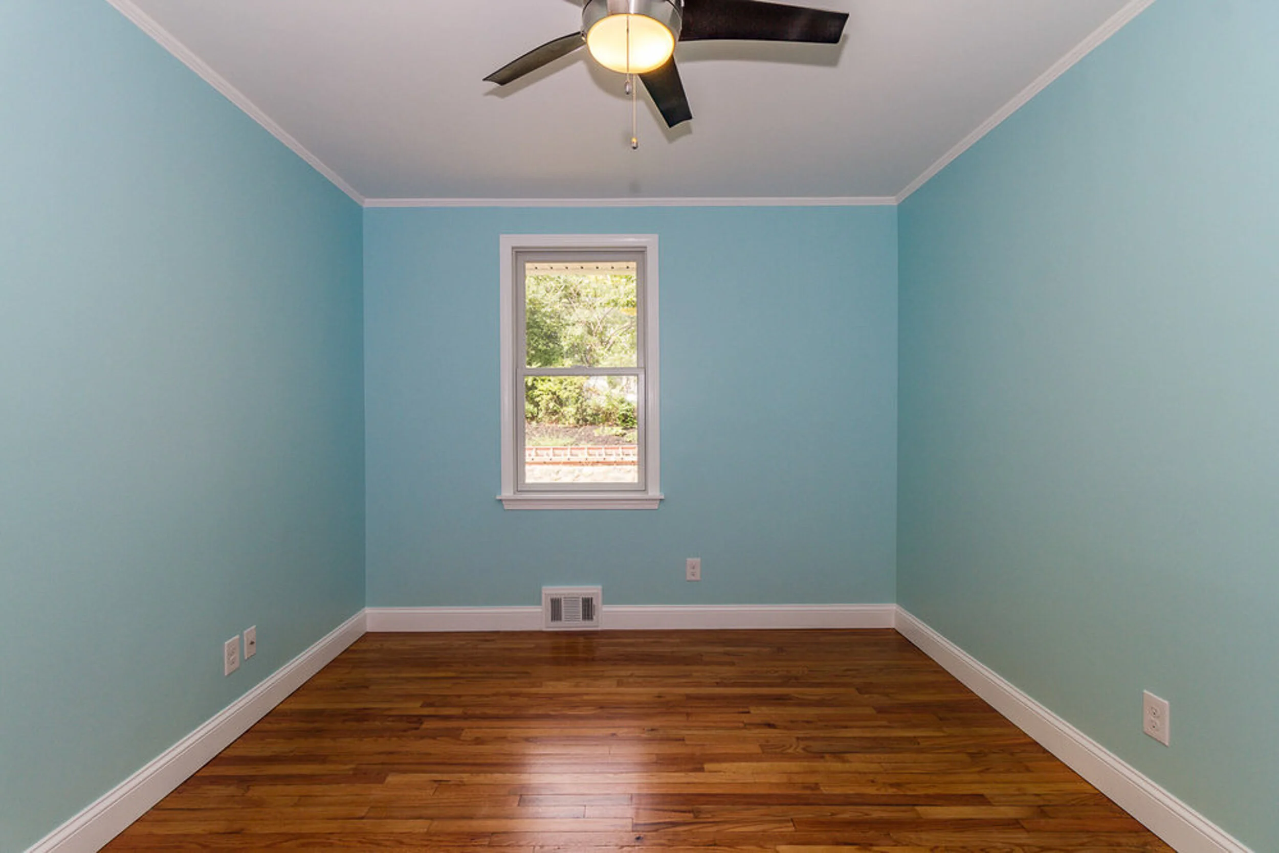 Bedroom with ceiling fan and refinished floors