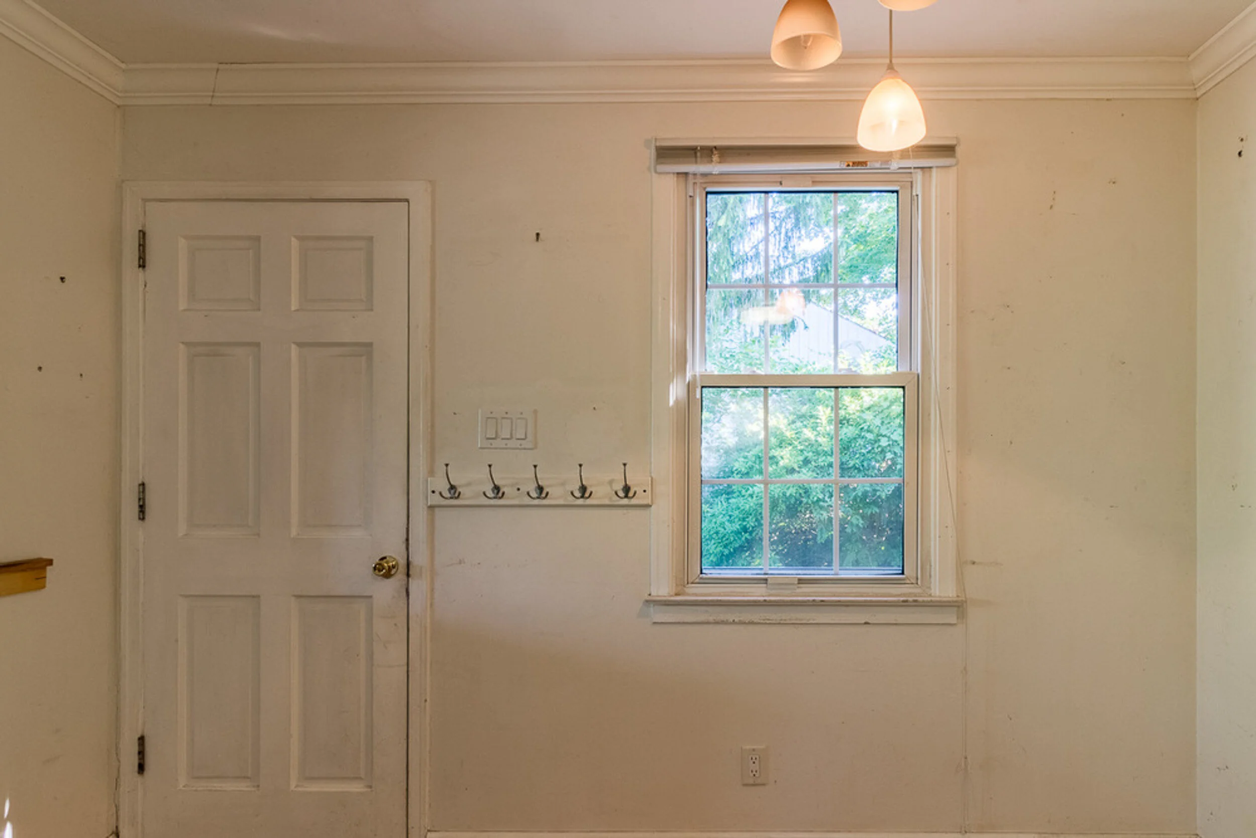 Before: mudroom with coat hooks
