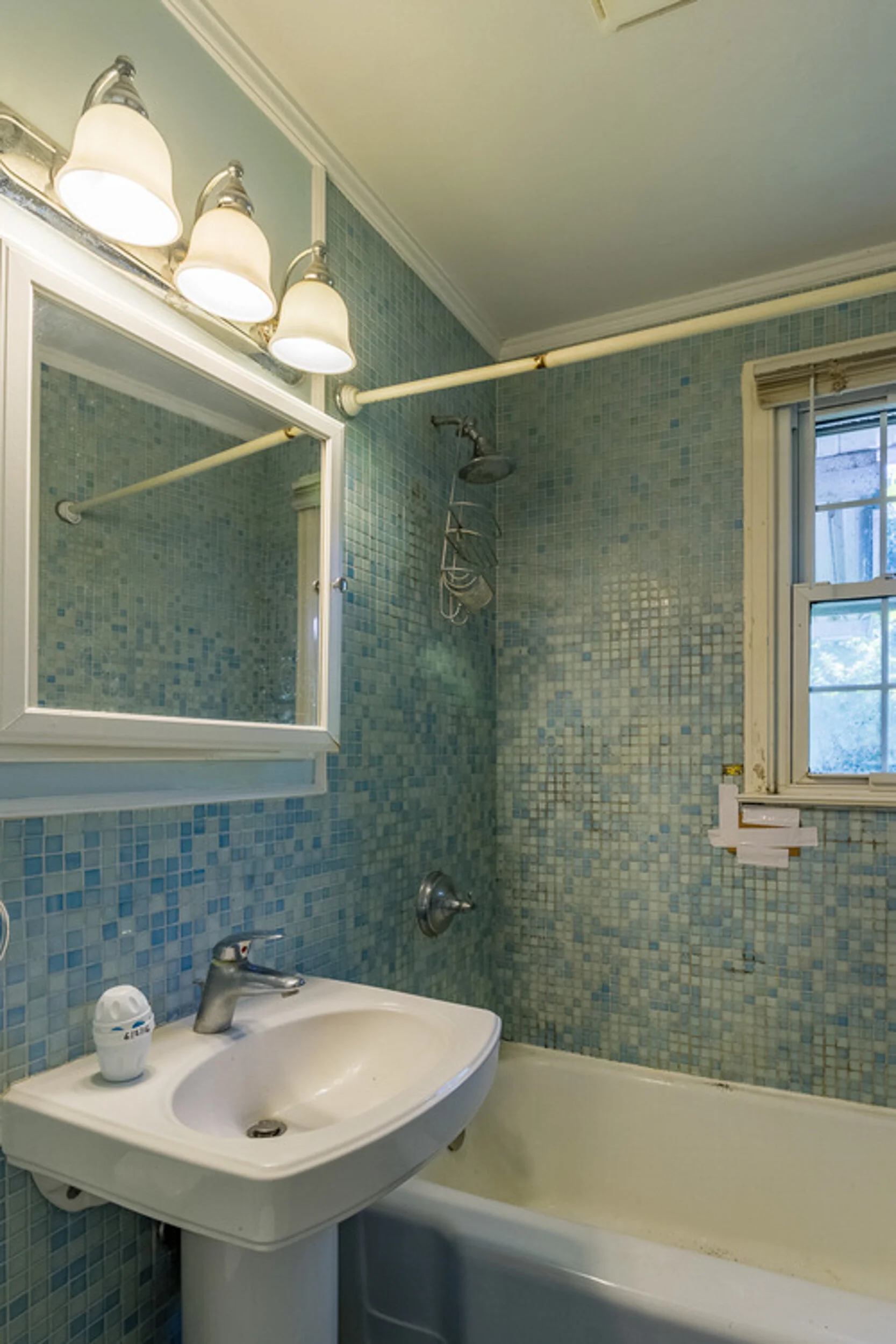 Before: bathroom with blue mosaic tile
