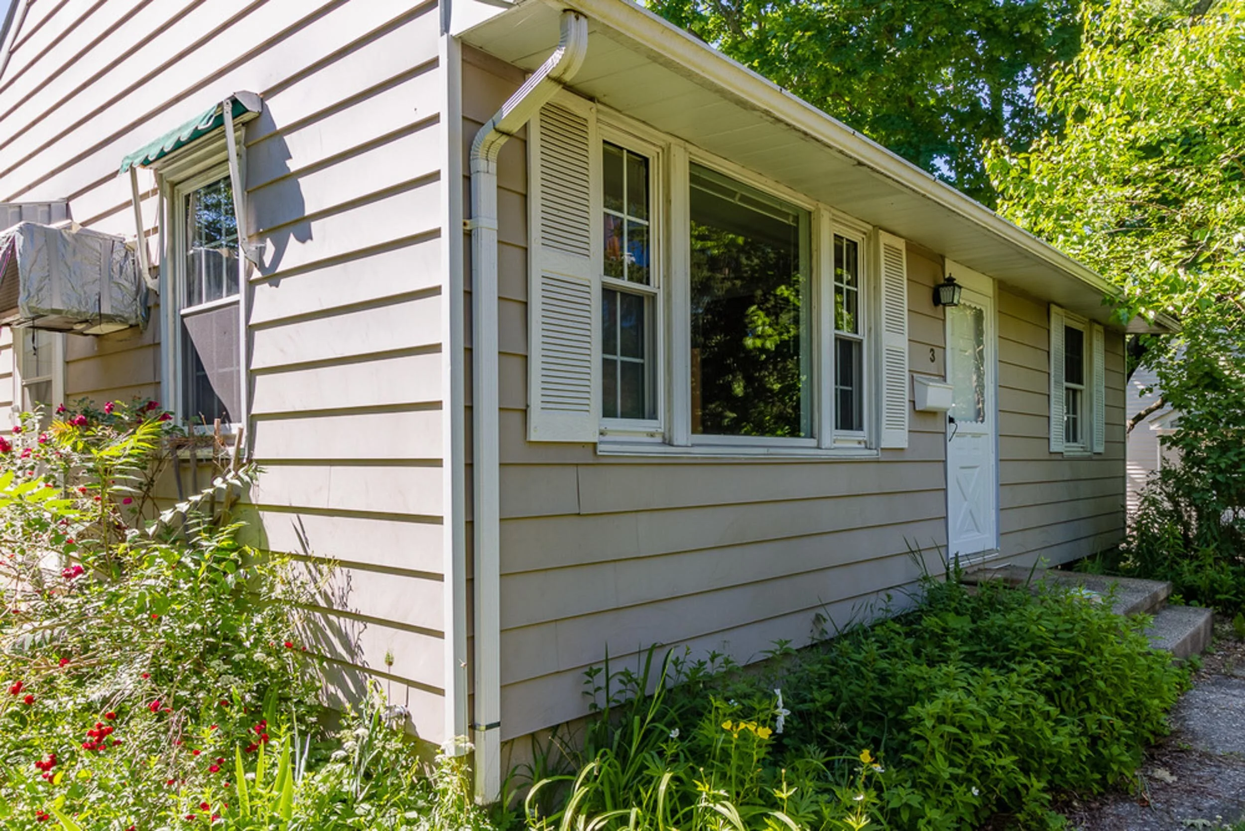 Before: original siding and windows