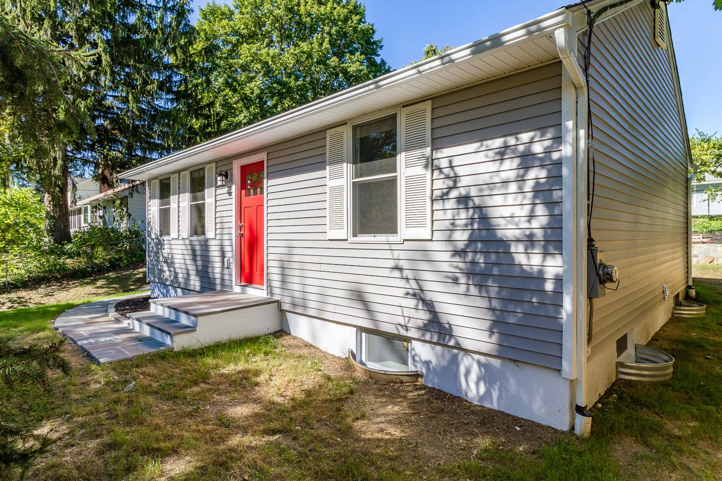 Side exterior with new siding and stone walkway