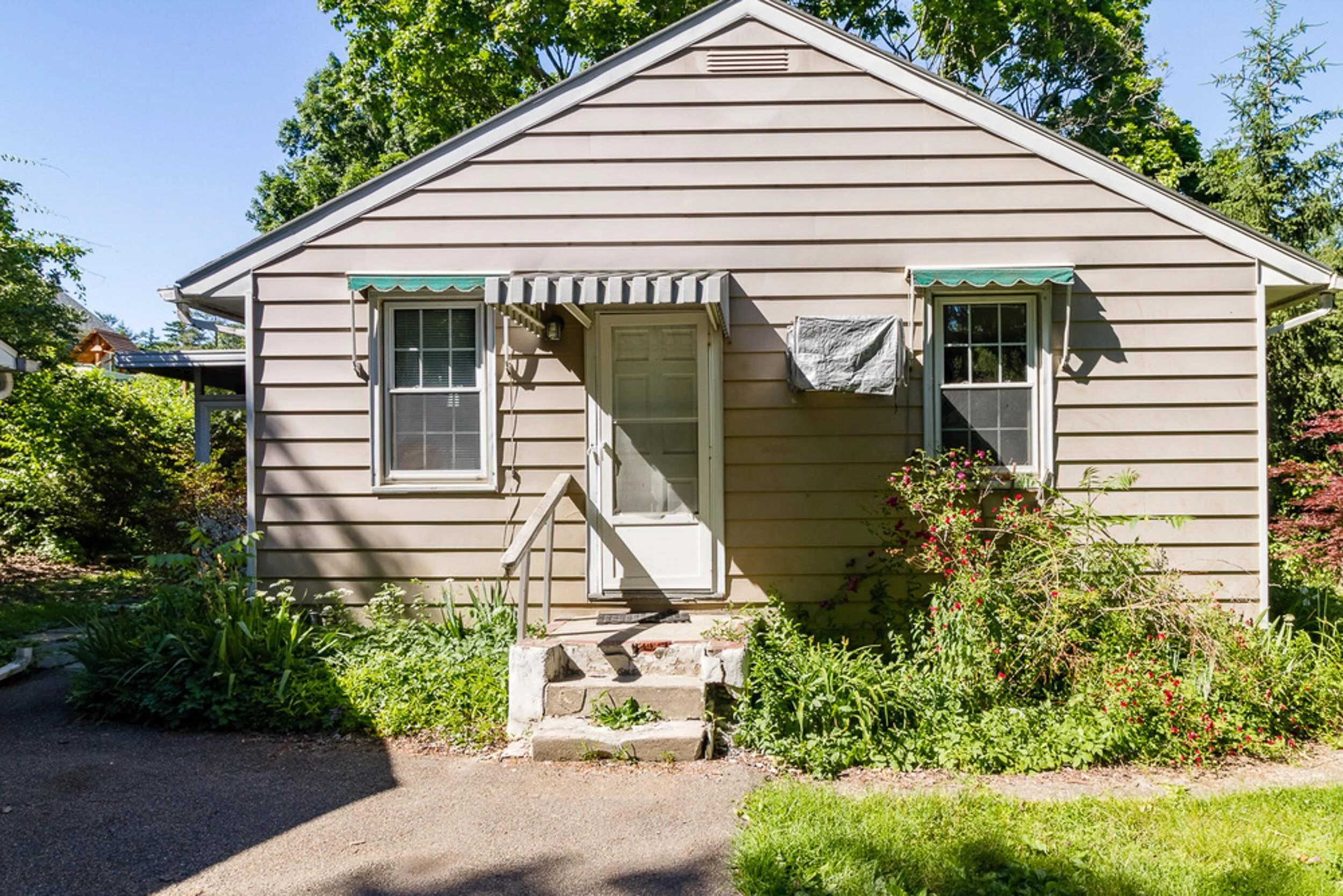 Before: original front entry with awnings