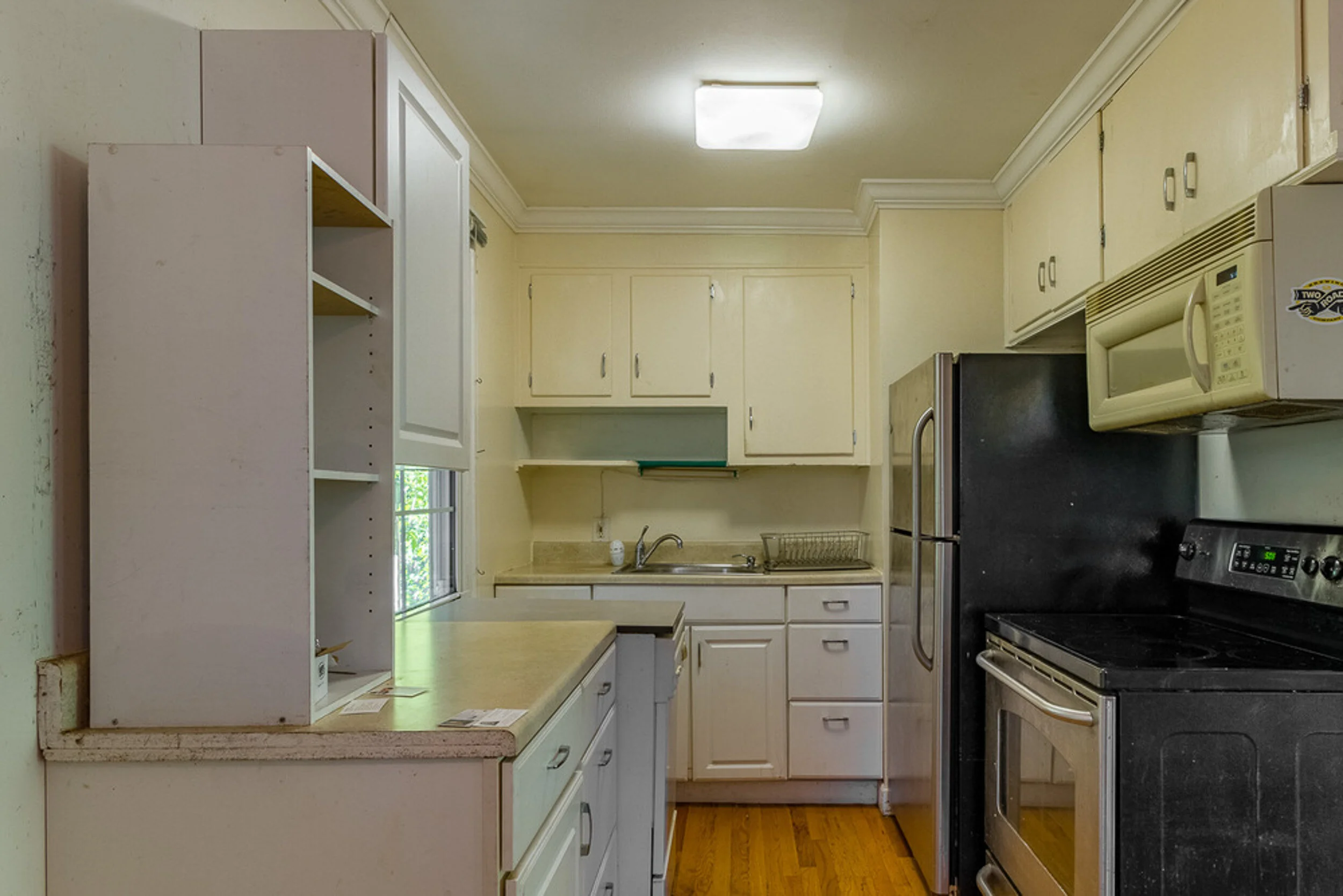 Before: kitchen with old cabinets and appliances