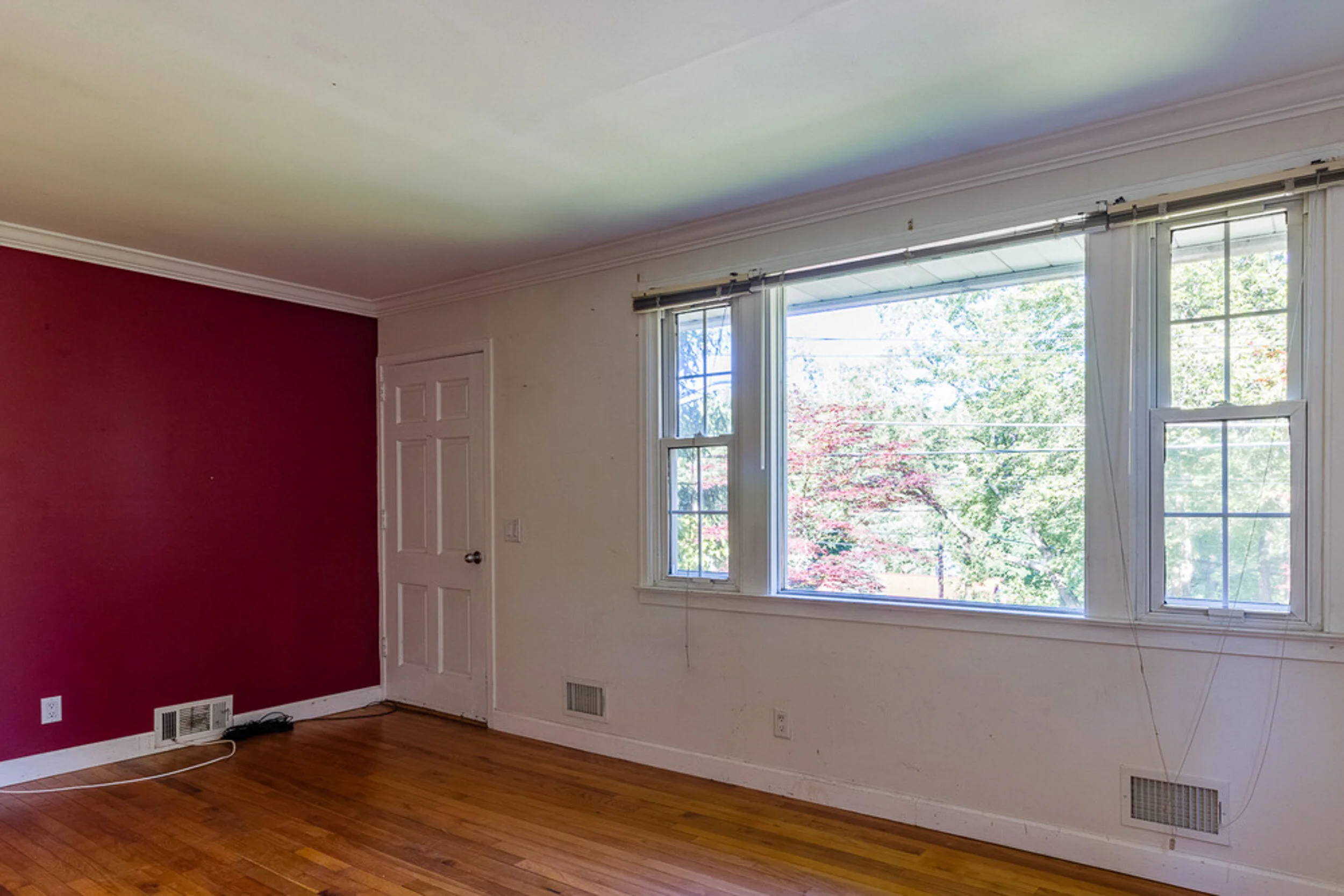 Before: living room with a red accent wall