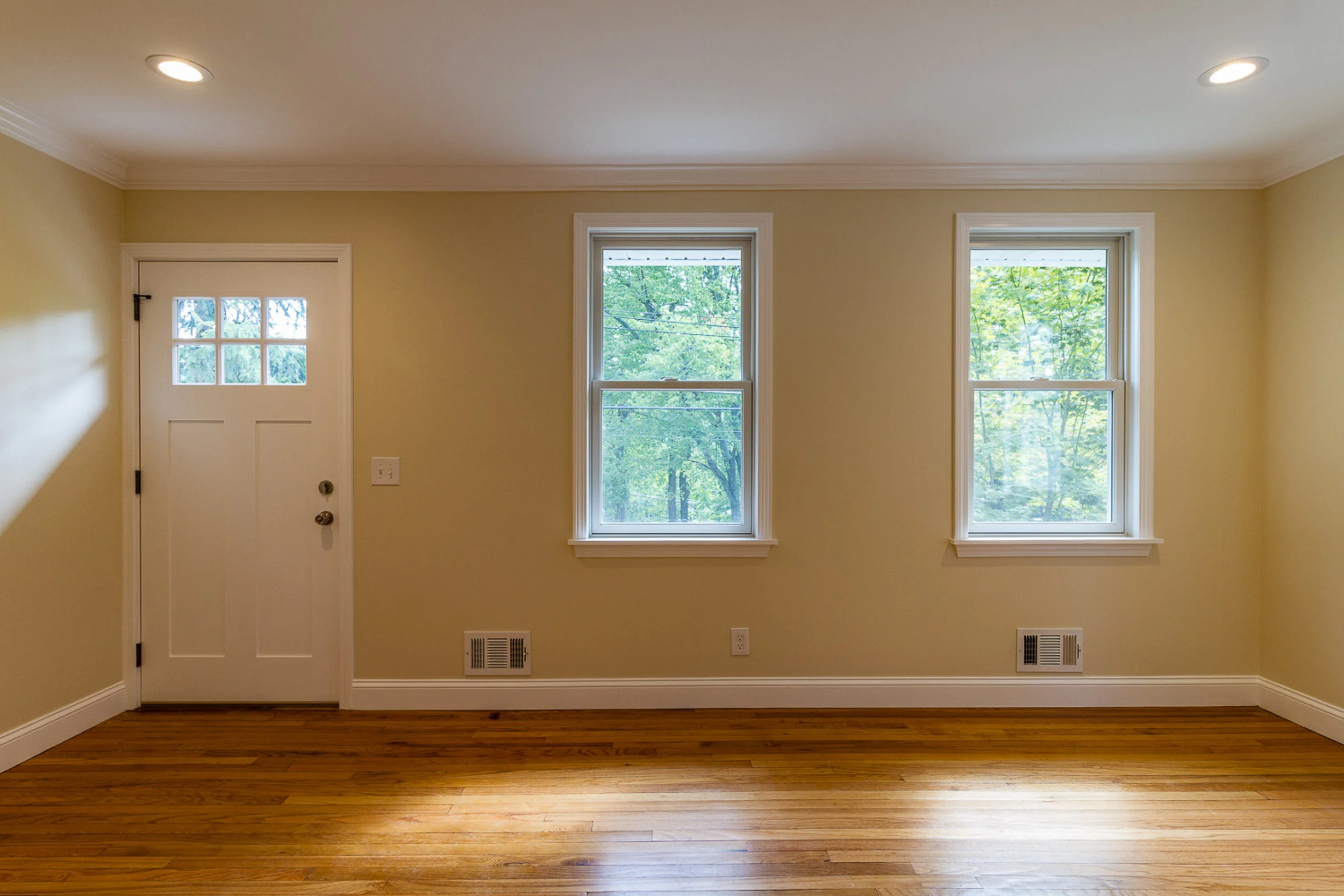 Living room with new craftsman door and windows