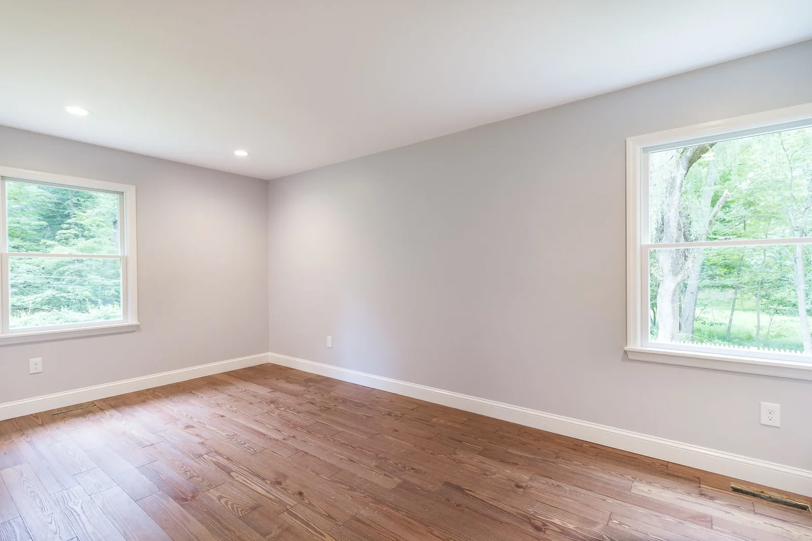 Bedroom with new windows and hardwood floors