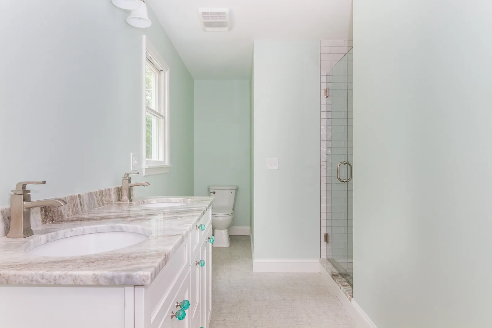 Double vanity with a glass shower