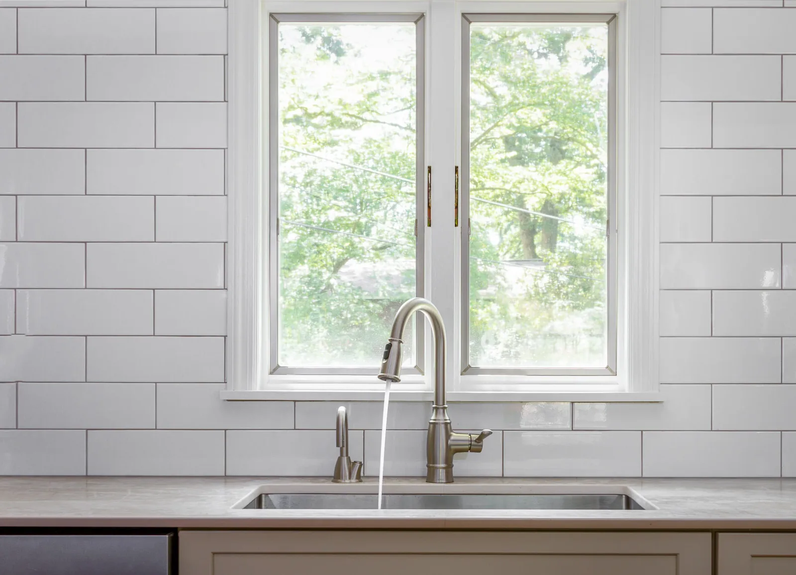 Faucet and subway tile at the kitchen sink