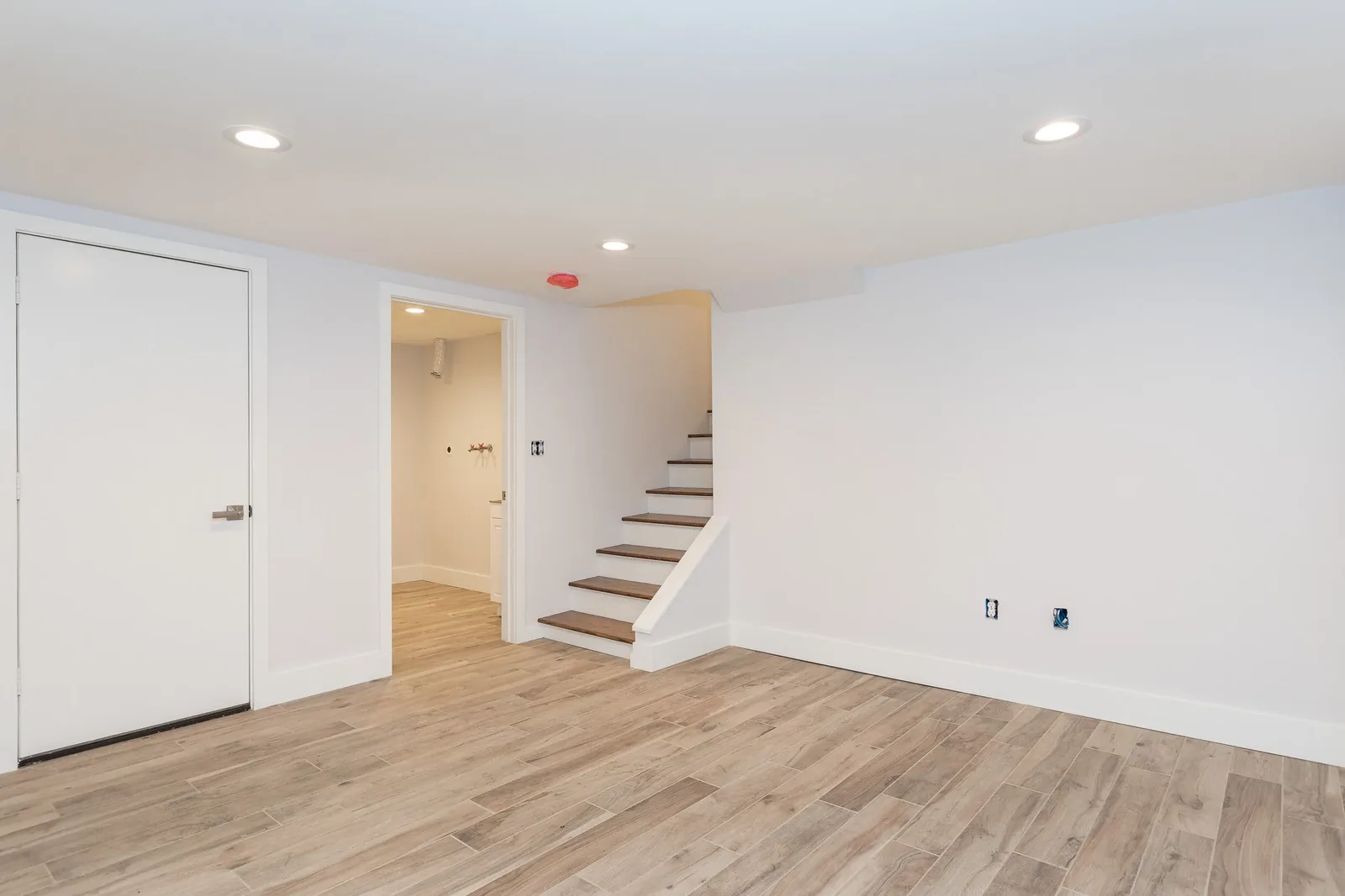 Finished lower level with staircase and laundry room