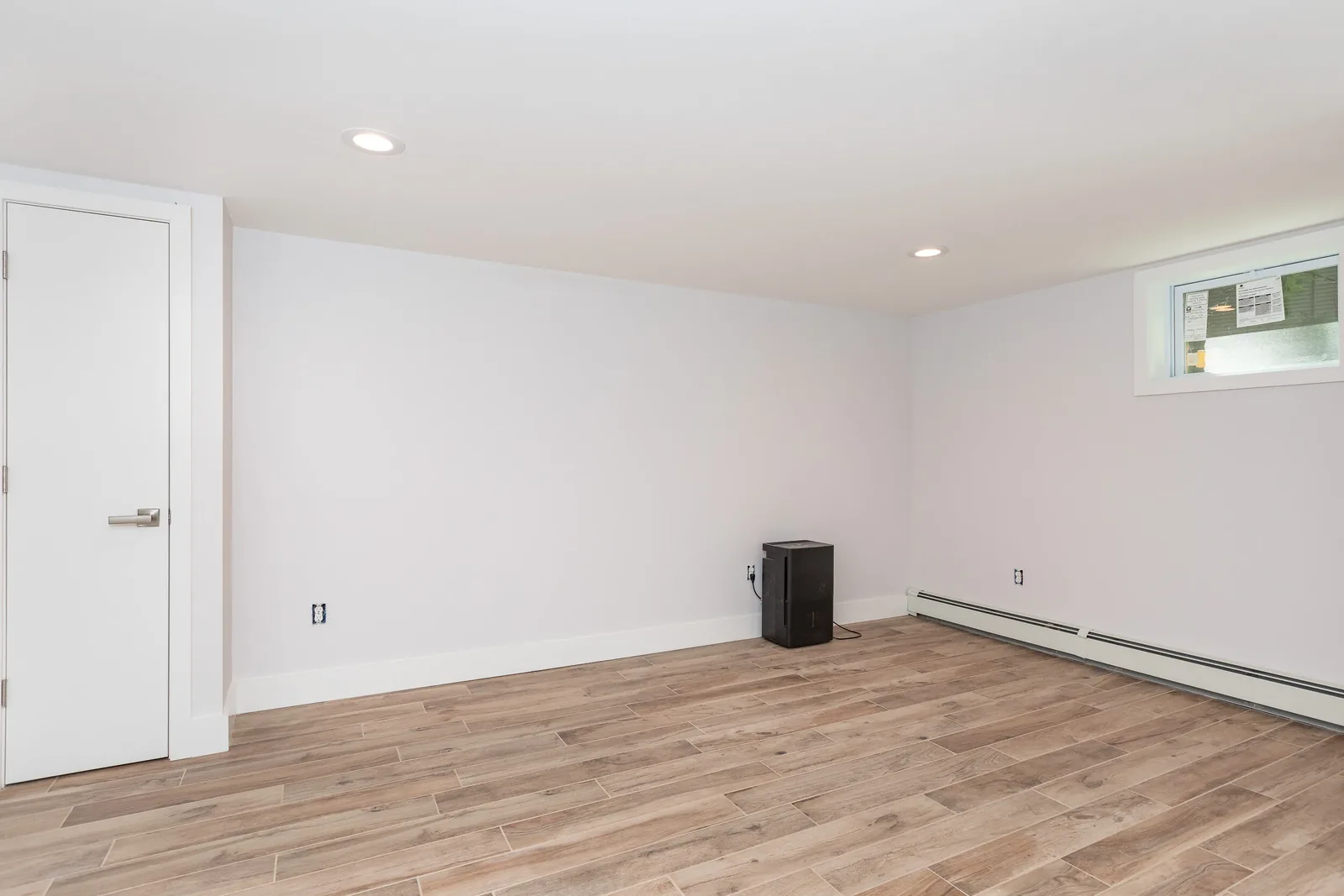 Lower level bedroom with wood-look tile floor