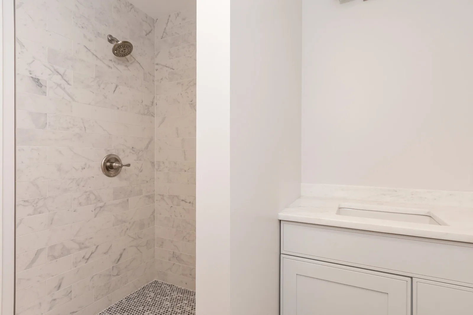 Marble tiled shower and vanity