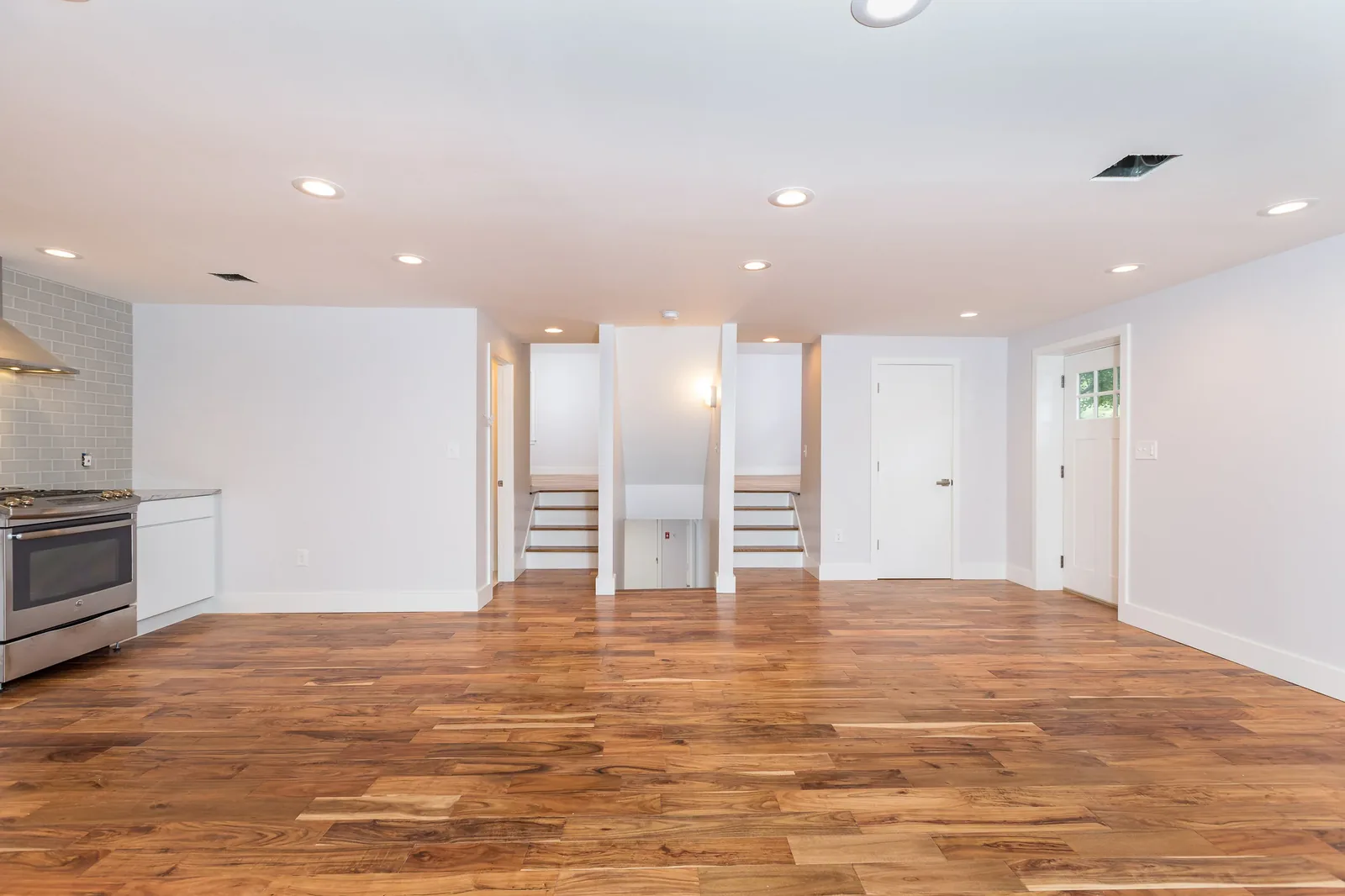 Open living and kitchen area with acacia hardwood floors
