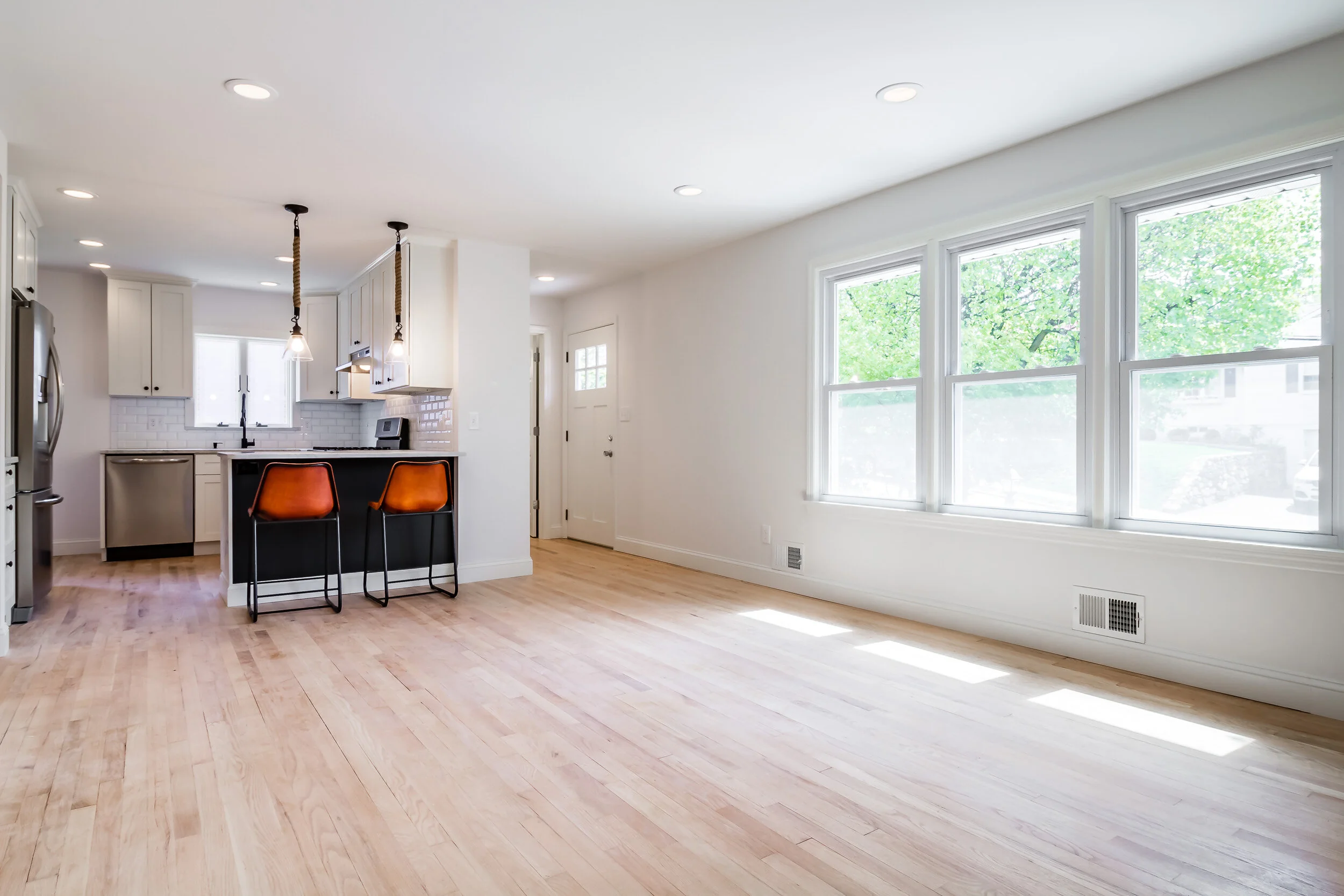 Open kitchen and living room with light hardwood floors at 45 Radnor Ave