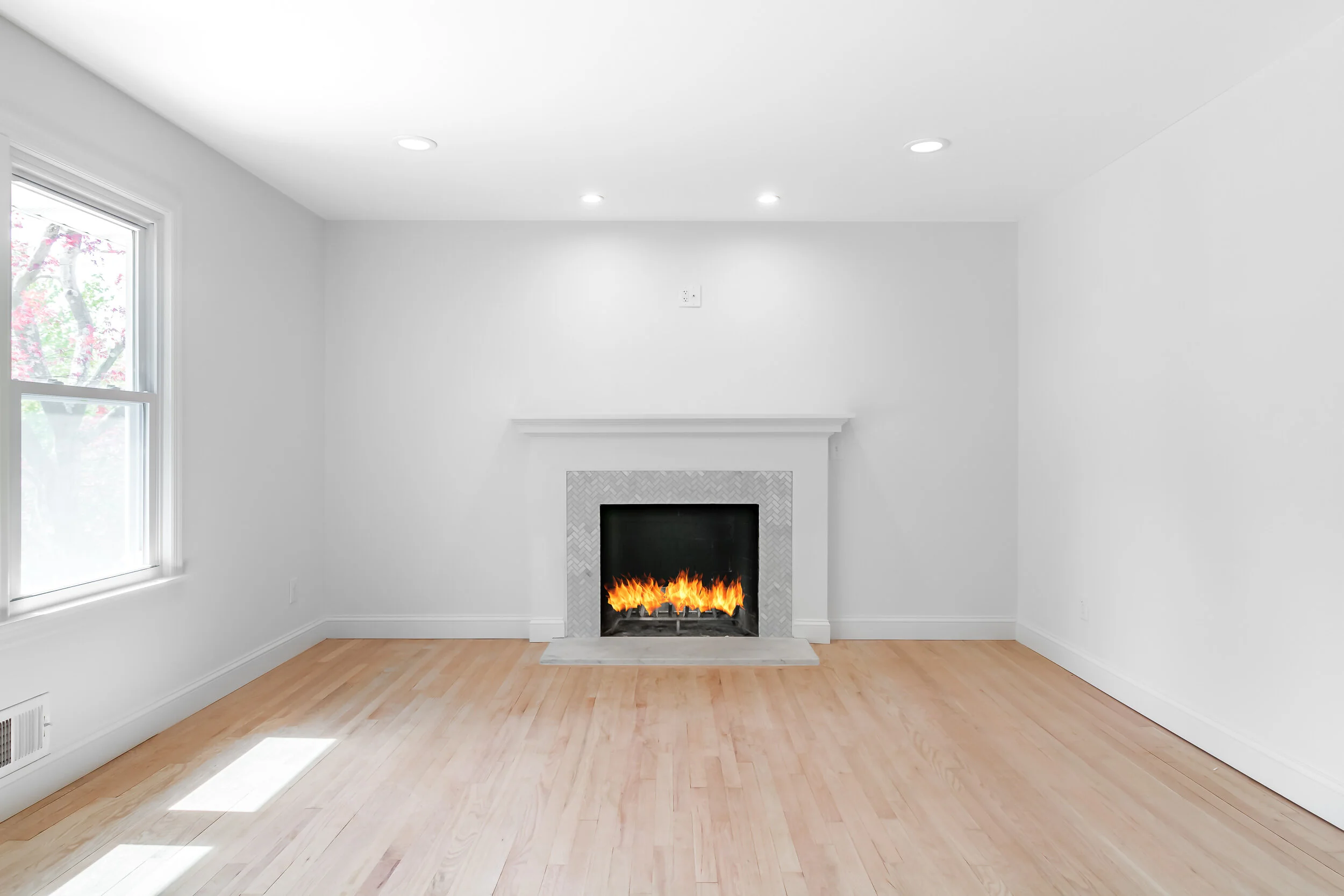 Living room with a herringbone-tile fireplace surround