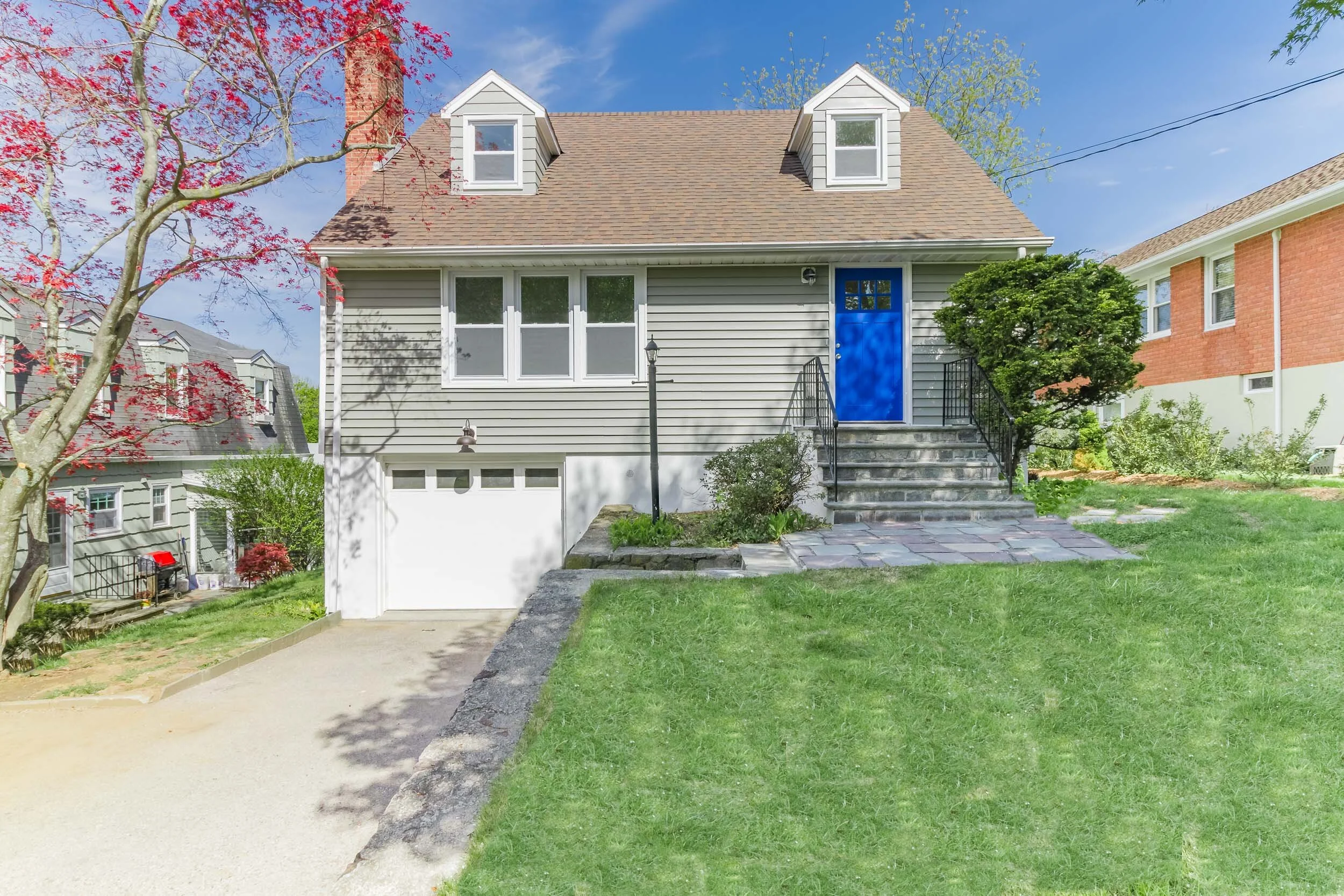 Front walkway and stone steps up to the blue entry door