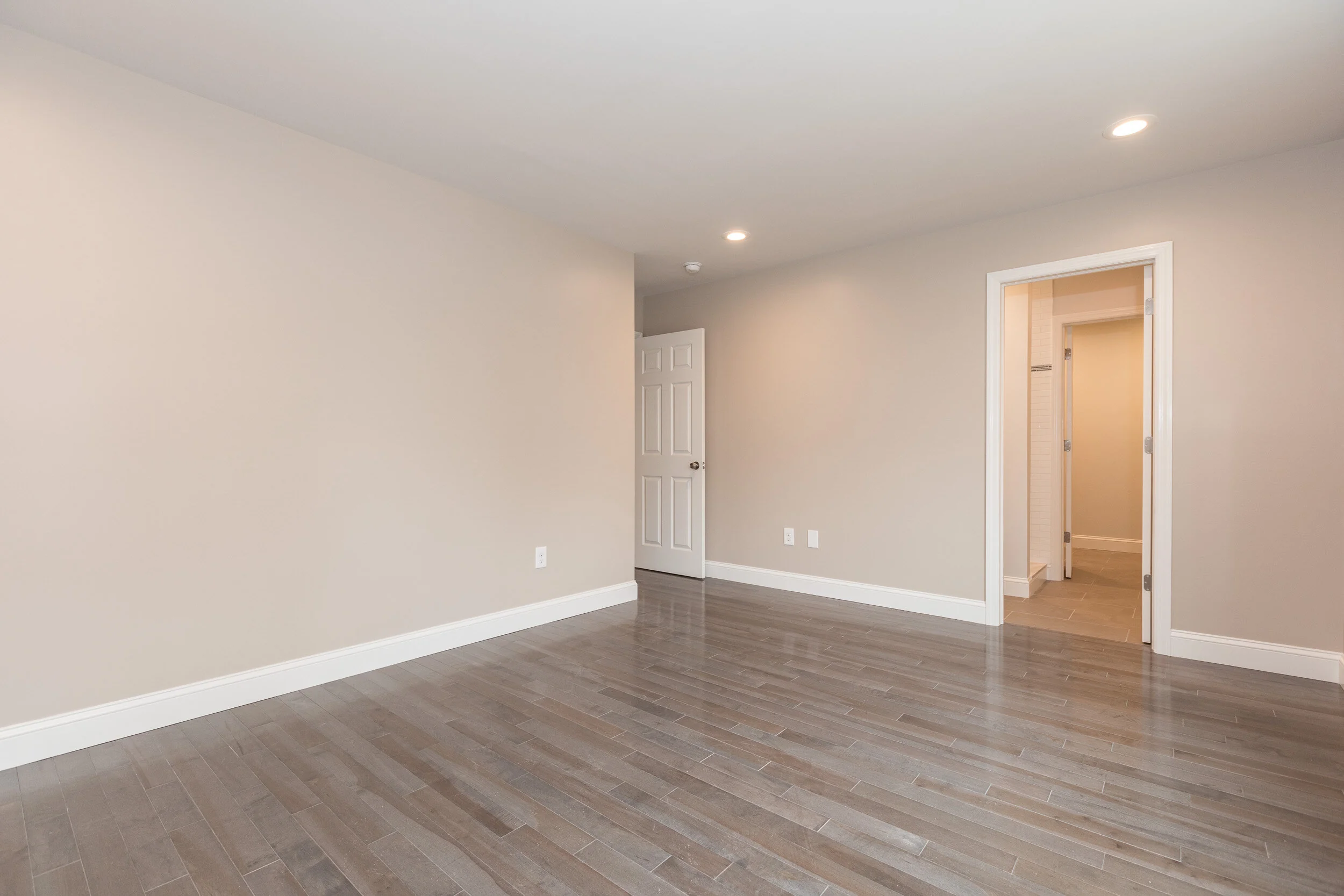 Bedroom with door through to the bathroom