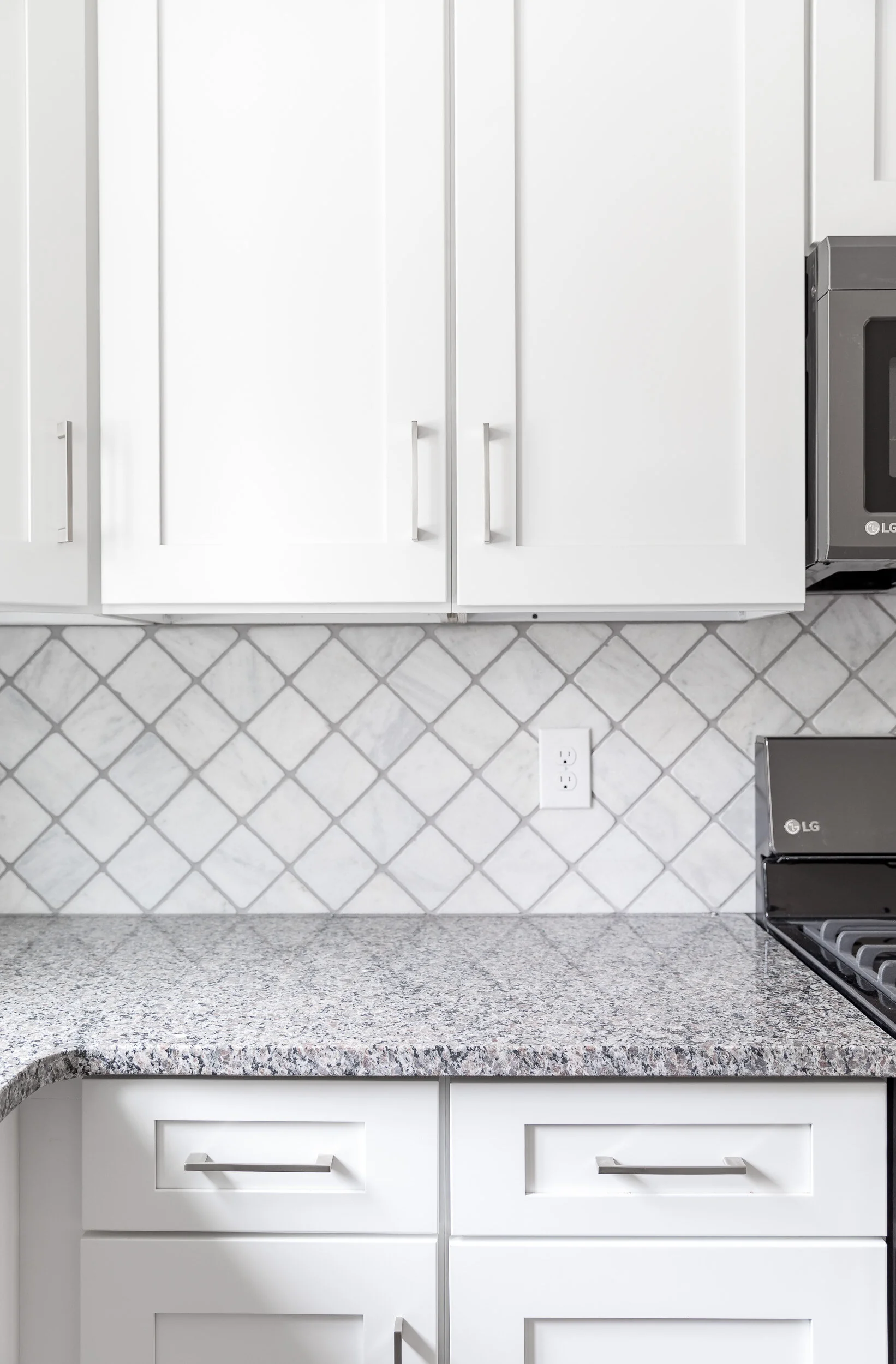 Upper cabinets over the granite counter and arabesque backsplash