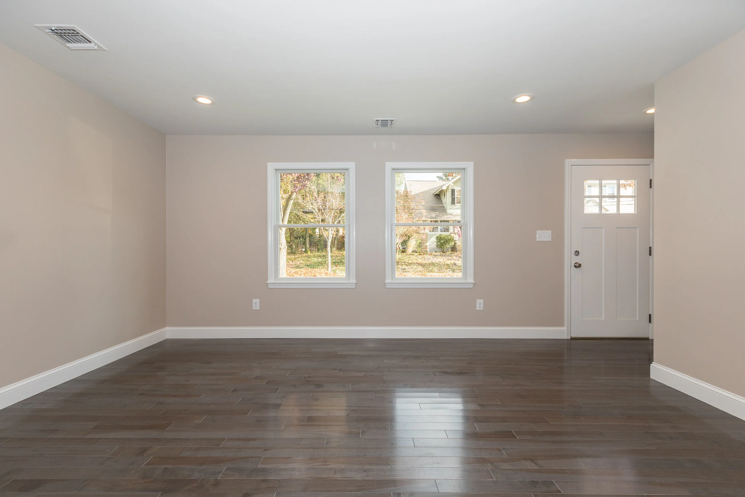 Bedroom with two windows and hardwood floors