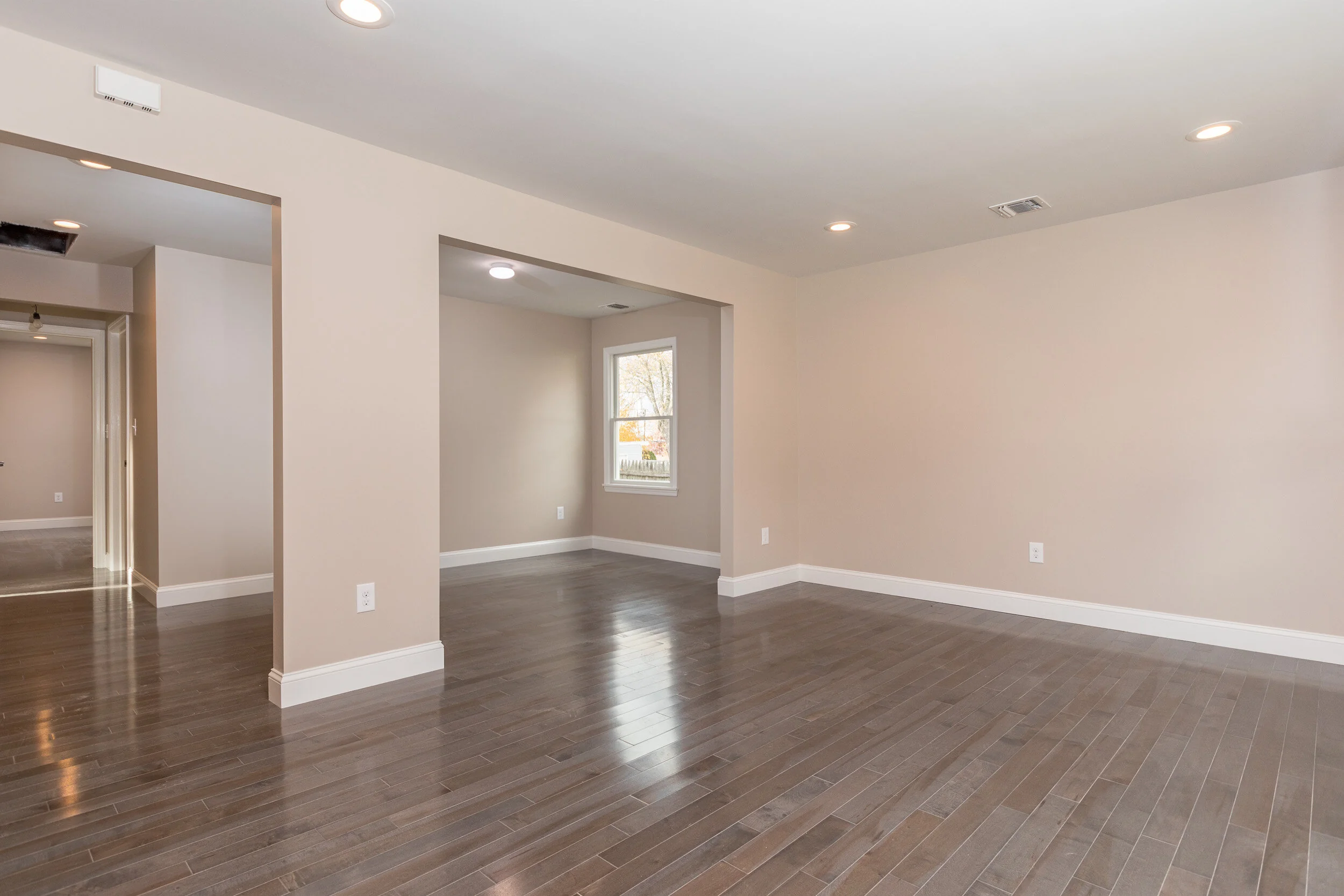 Living room with recessed lighting and craftsman entry door