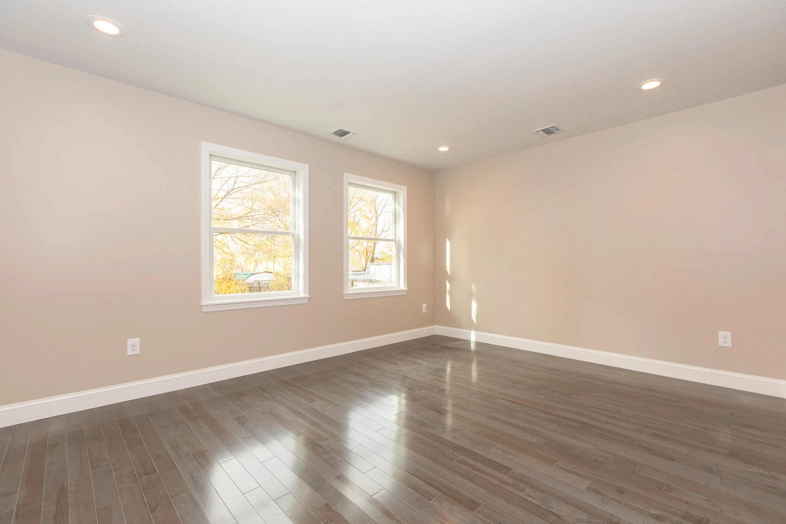 Living room with dark hardwood floors and front entry